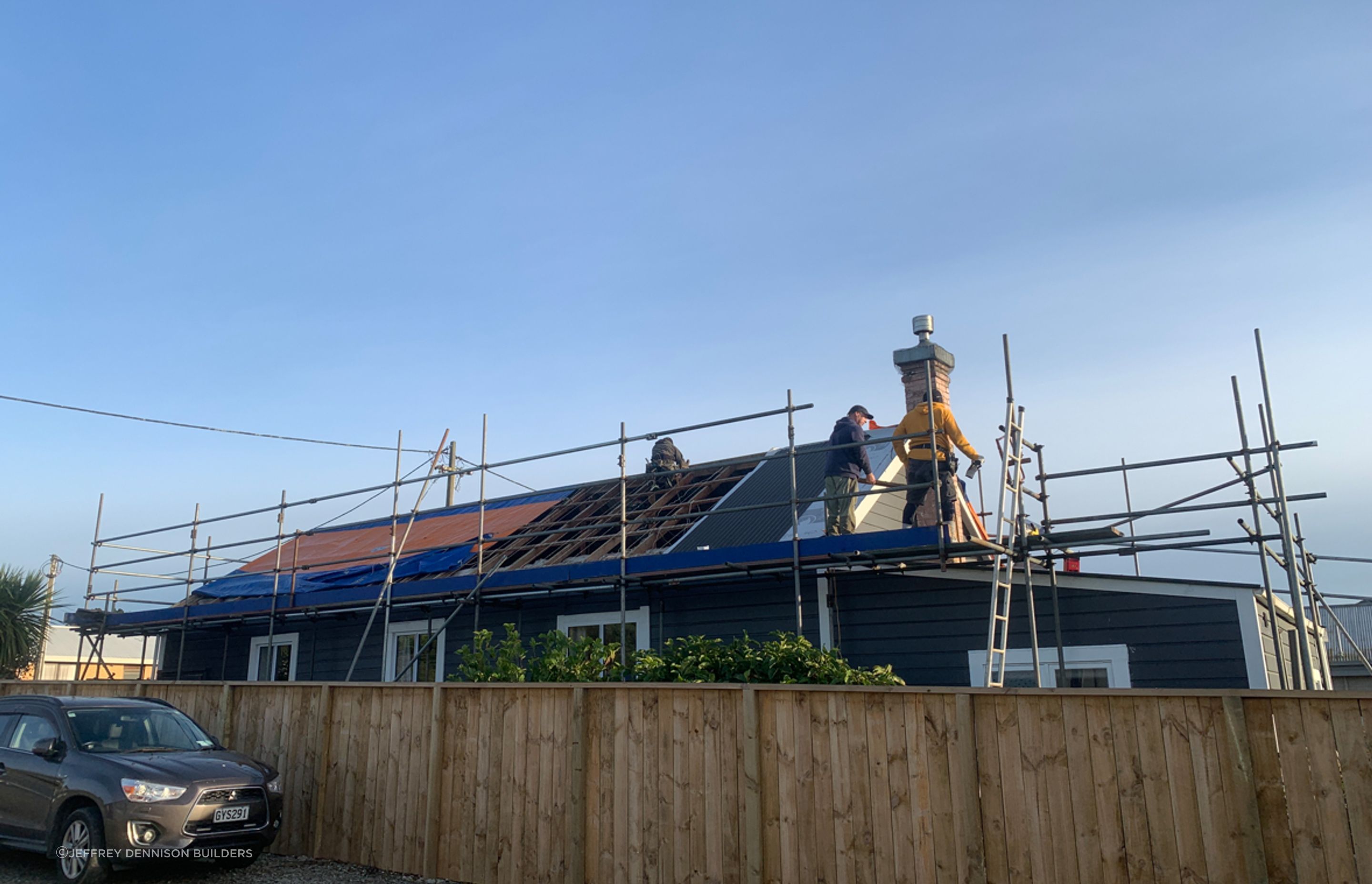 Reroofing underway, taking off the old roofing, repairing any damaged purlins and affixing new roofing underlay and sheets of long run roofing.