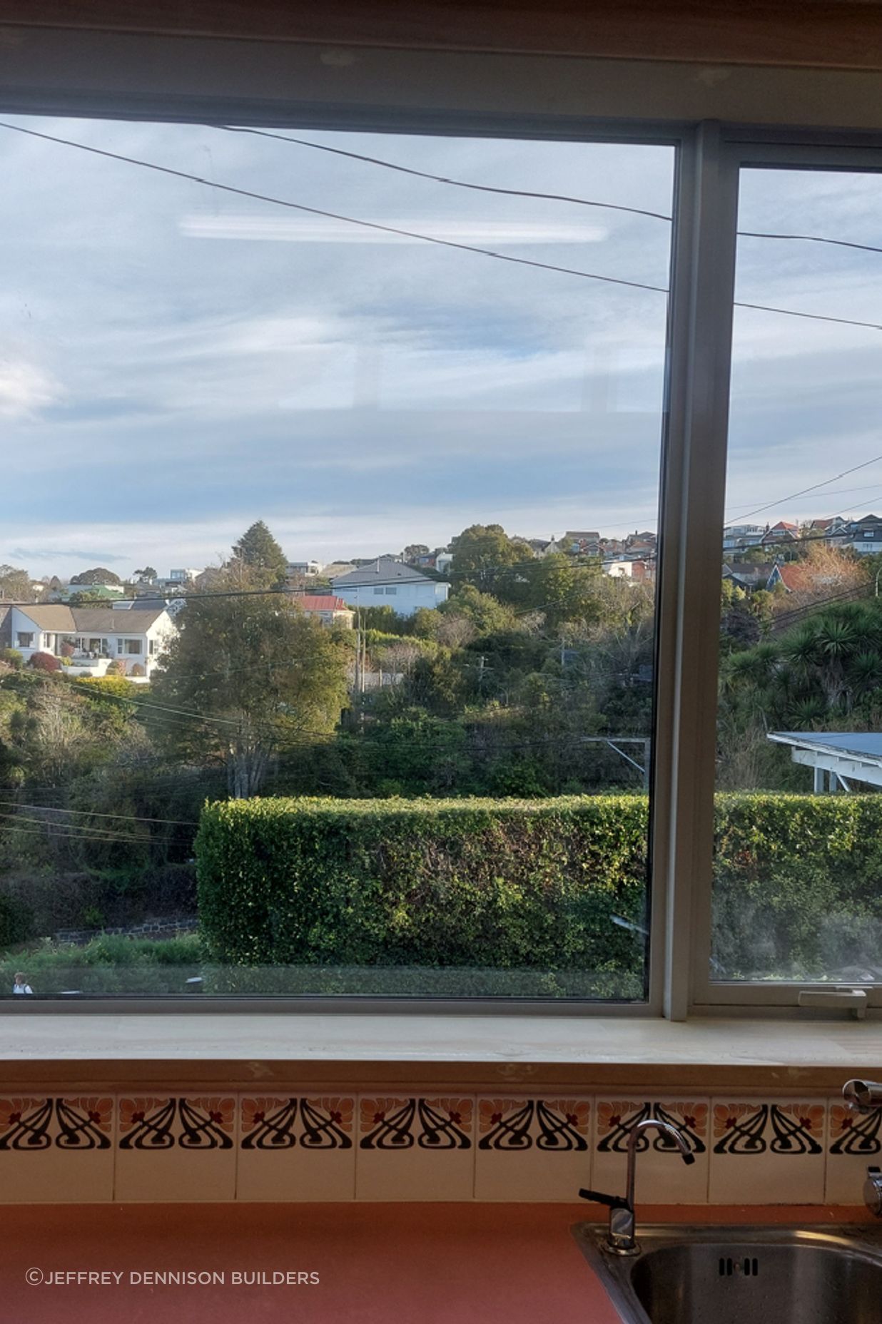 8-19-Tweed-St-Roslyn-Dunedin-Newly-installed-double-glazed-window-in-the-kitchen-being-stopped-and-sanded-on-the-reveal-and-trims-JDBuilders.jpg