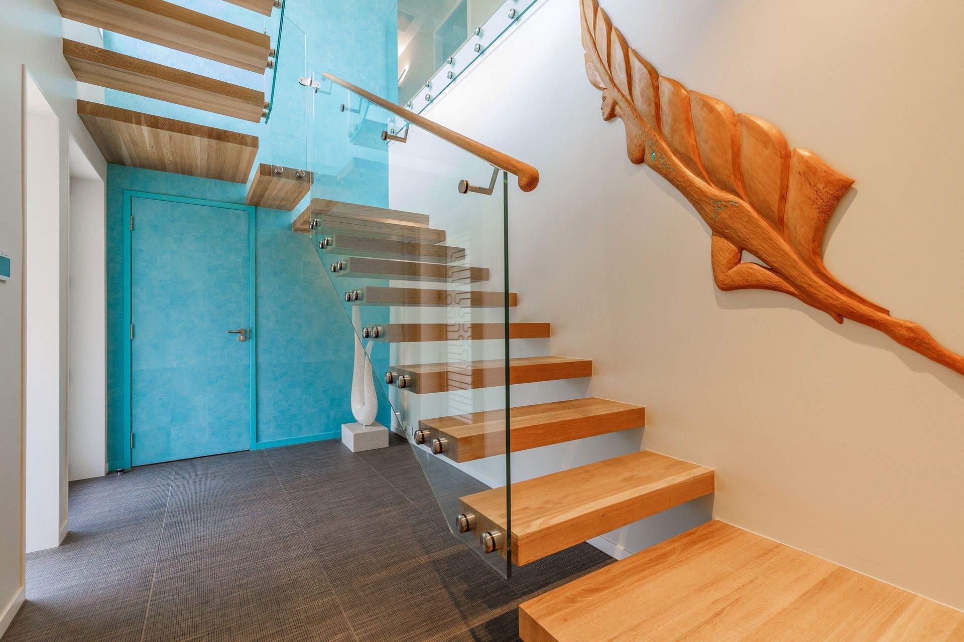 The feature wallpaper is Elitis Wallpaper Natives Maori. It runs floor to ceiling over two stories and provides the tone for the upstairs areas. The openness created by the floating staircase is credit to Miles Heine from Mccoy + Heine Architects.