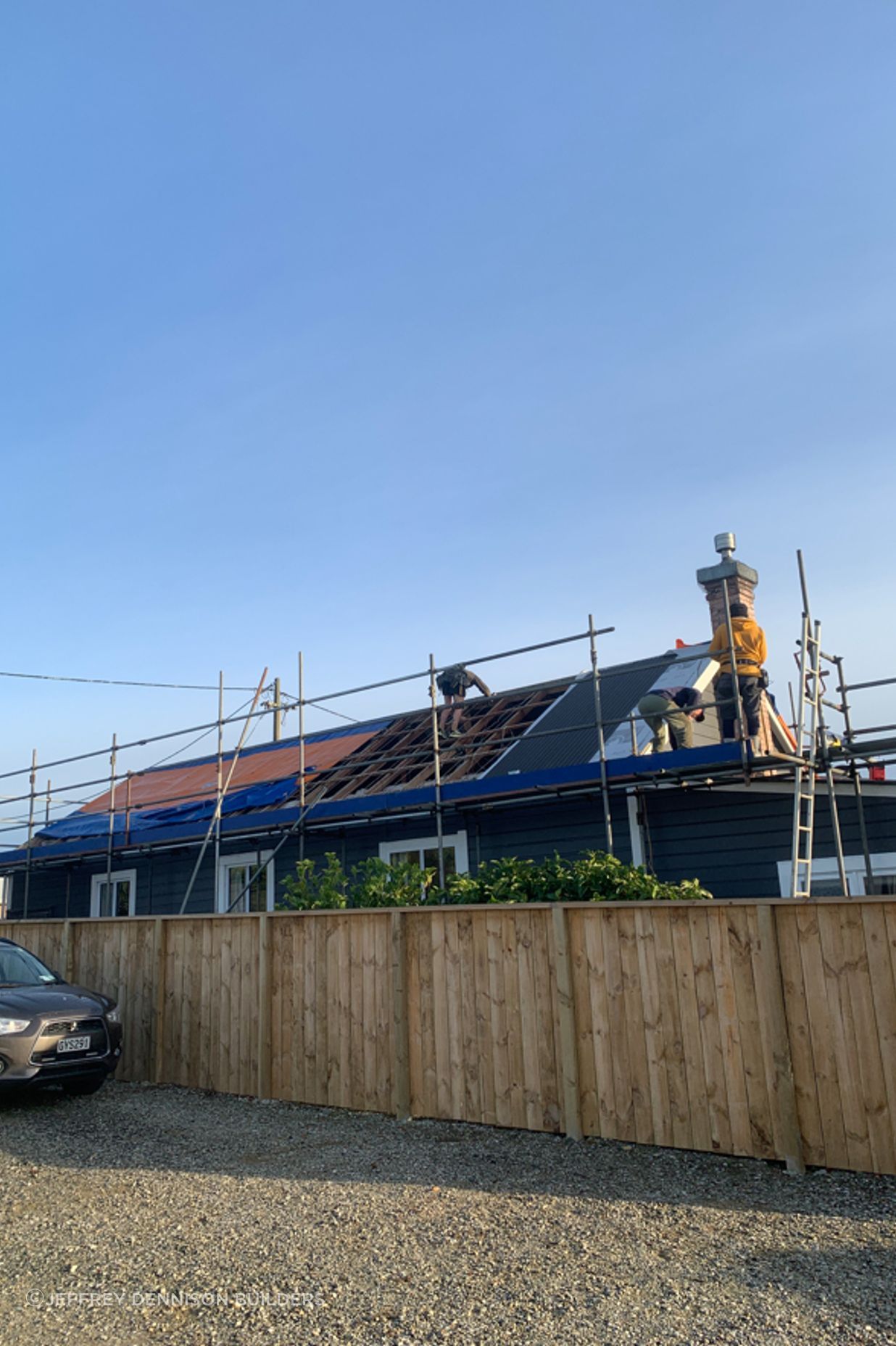 Reroofing underway, taking off the old roofing, repairing any damaged purlins and affixing new roofing underlay and sheets of long run roofing.