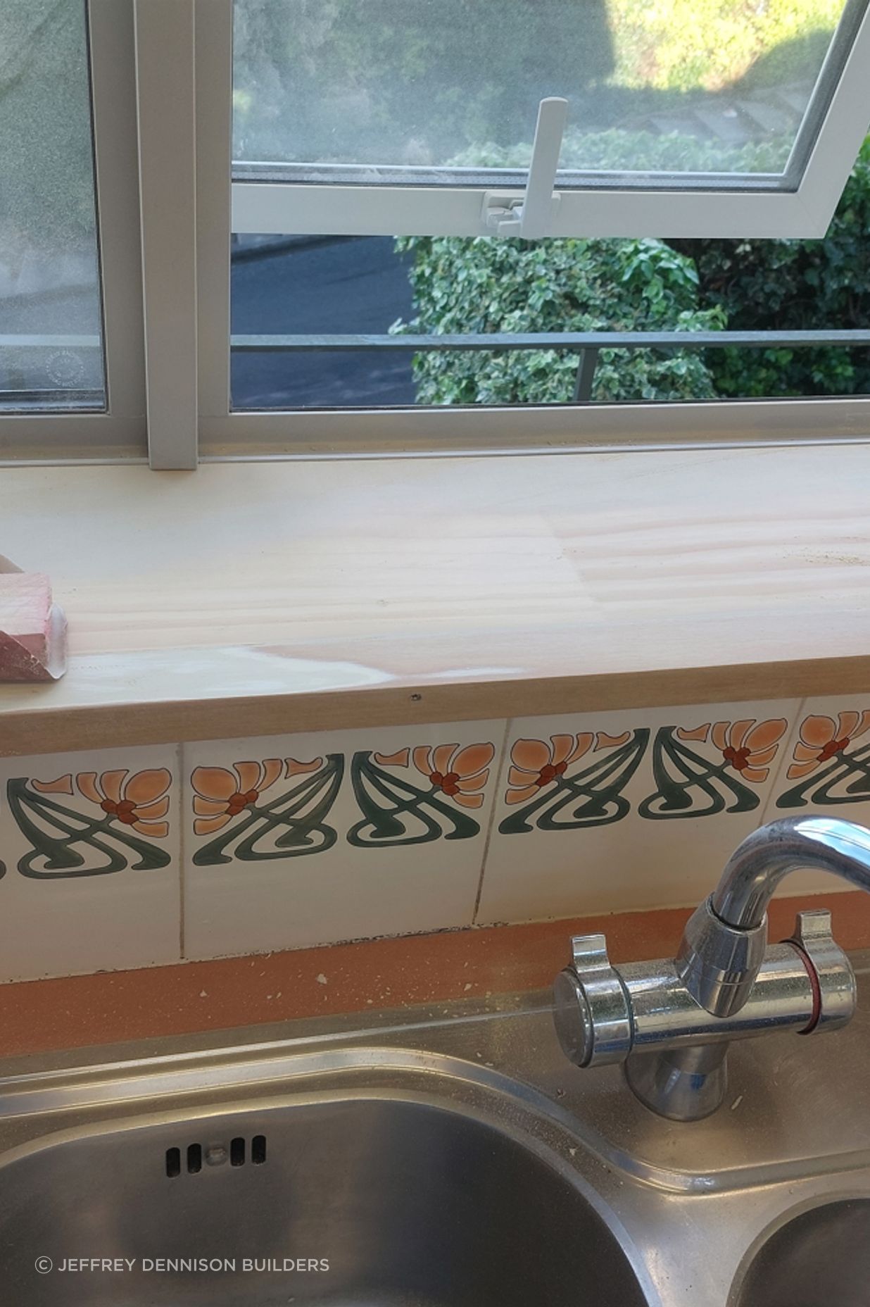 9-19-Tweed-St-Roslyn-Dunedin-Newly-installed-double-glazed-window-in-the-kitchen-being-sanded-to-ensure-a-perfect-finish-ready-for-painting-JDBuilders.jpg
