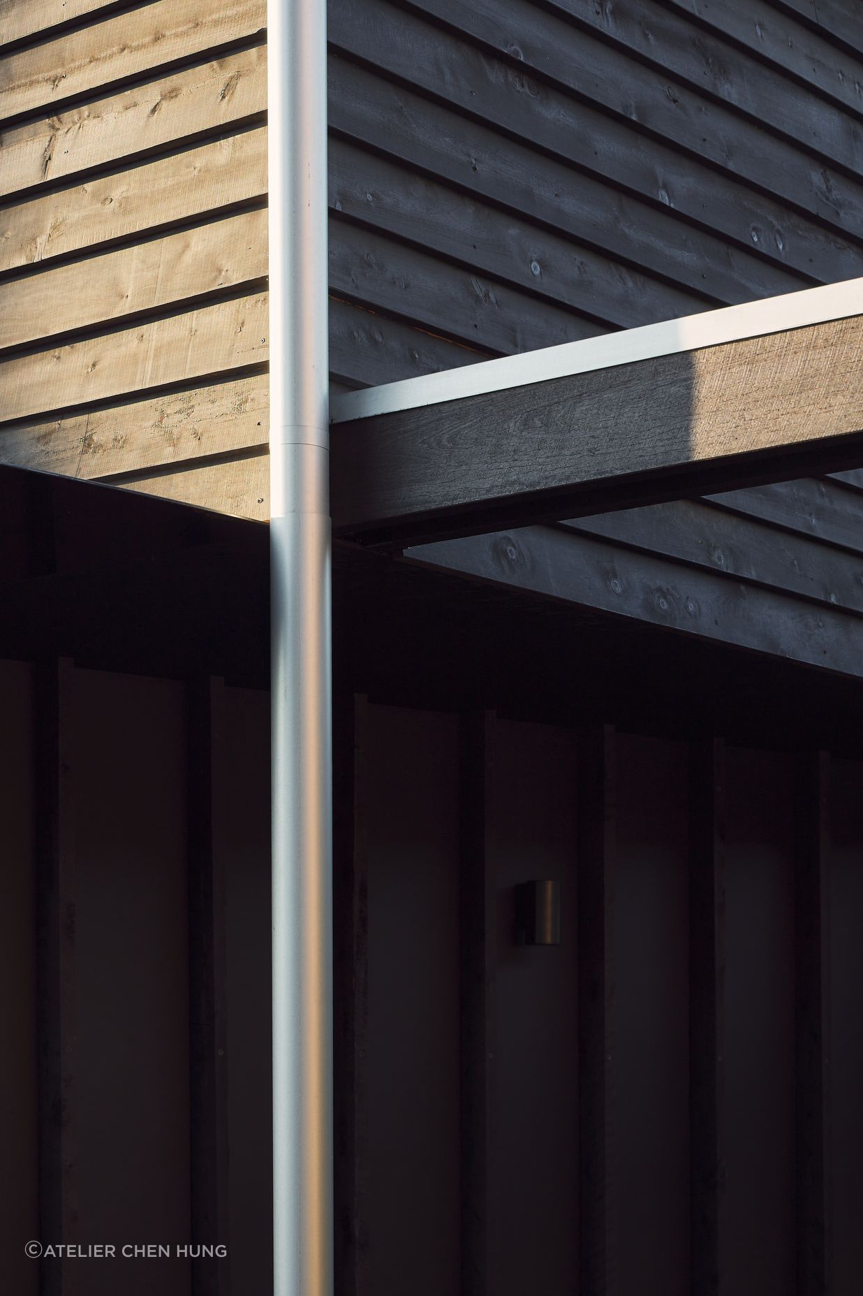 Black stained timber cladding and expressed battens create a muted silhouette for this traditional worker’s cottage, subtly revealing its character and texture throughout the day.