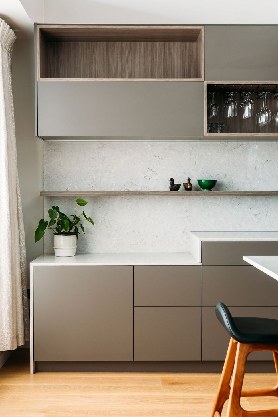 A storage zone where work-from-home equipment can be stored while cooking.