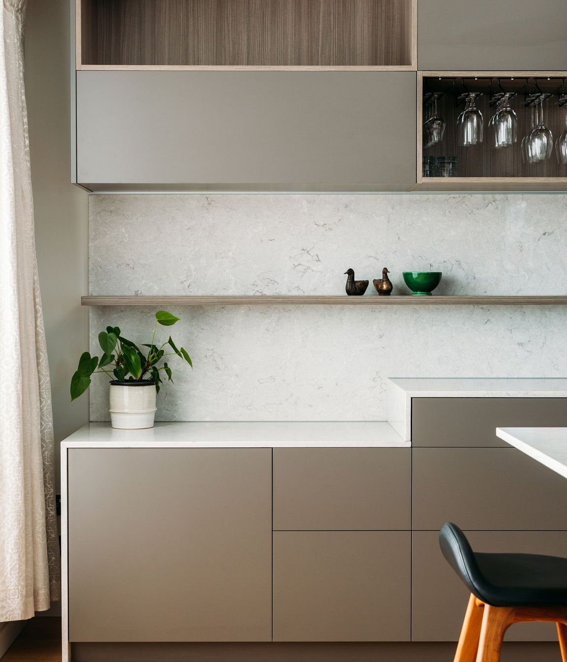 A storage zone where work-from-home equipment can be stored while cooking.