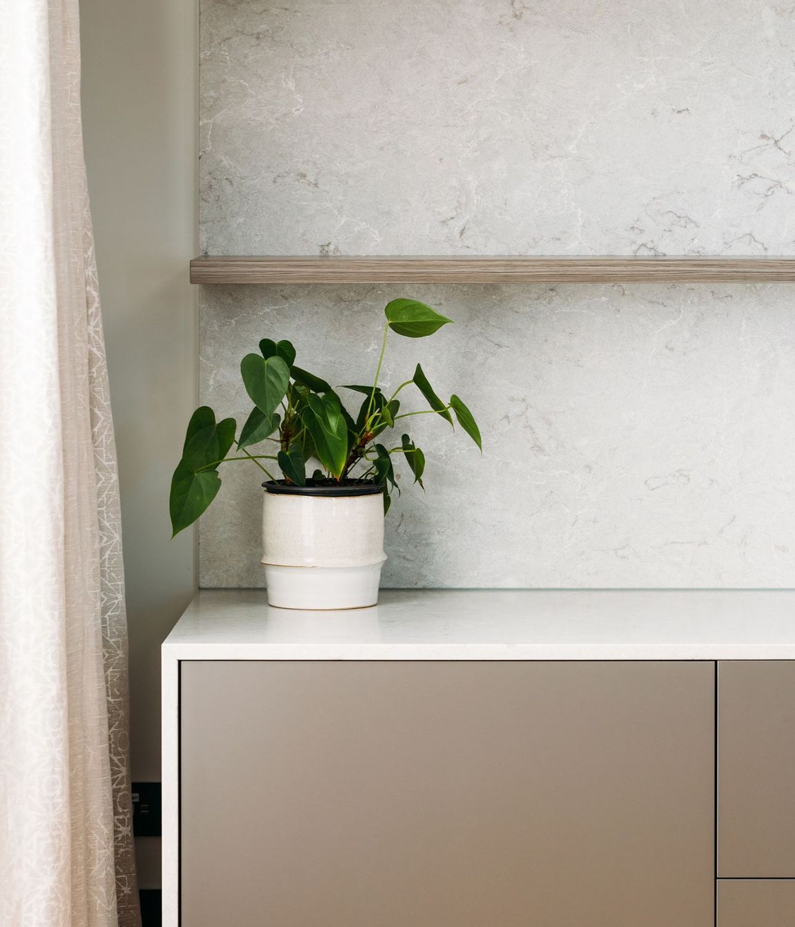 Melteca 'Iron Ore' Pearl and Ceasarstone Bianco Drift waterfall benchtop.