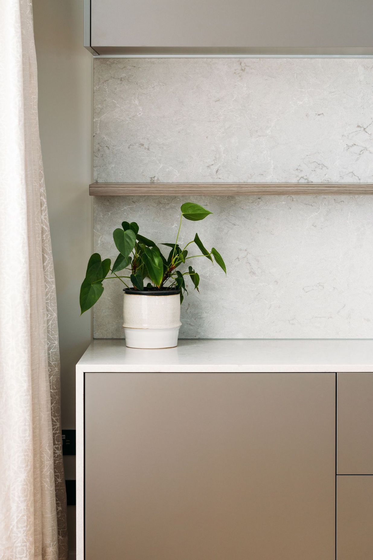 Melteca 'Iron Ore' Pearl and Ceasarstone Bianco Drift waterfall benchtop.