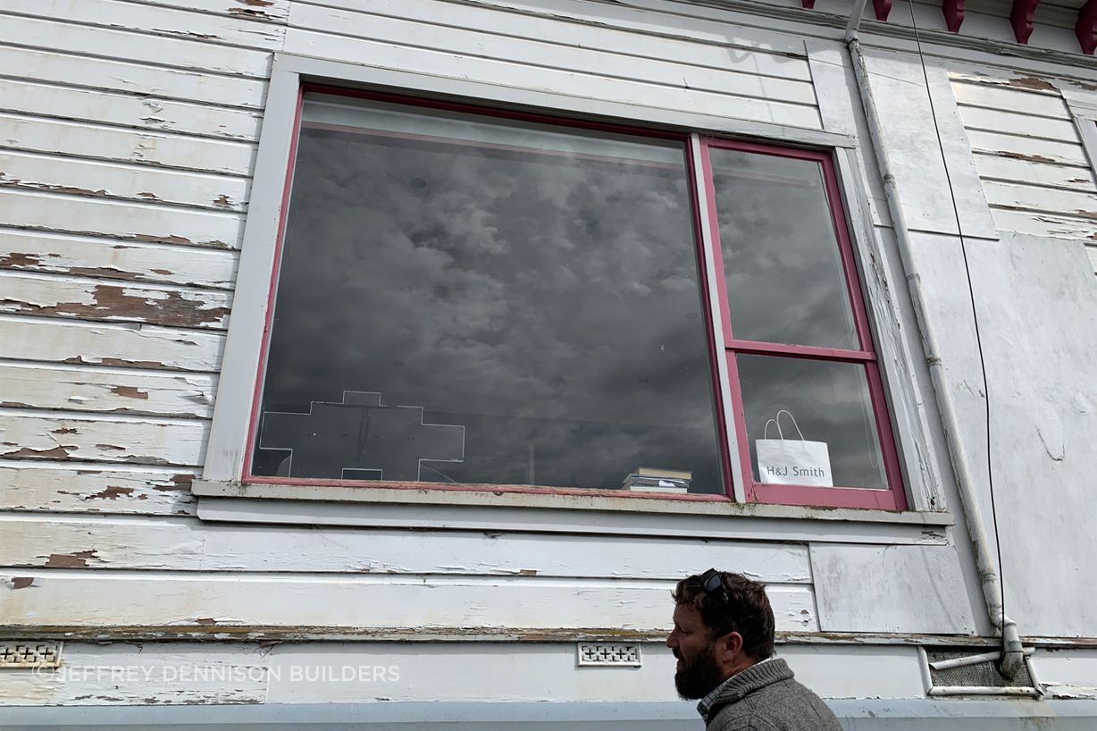 B5-9-Fifield-St-Roslyn-Dunedin-Jeff-inspecting-damaged-weatherboards-and-window-on-the-east-side-before-renovation-JDBuilders.jpg