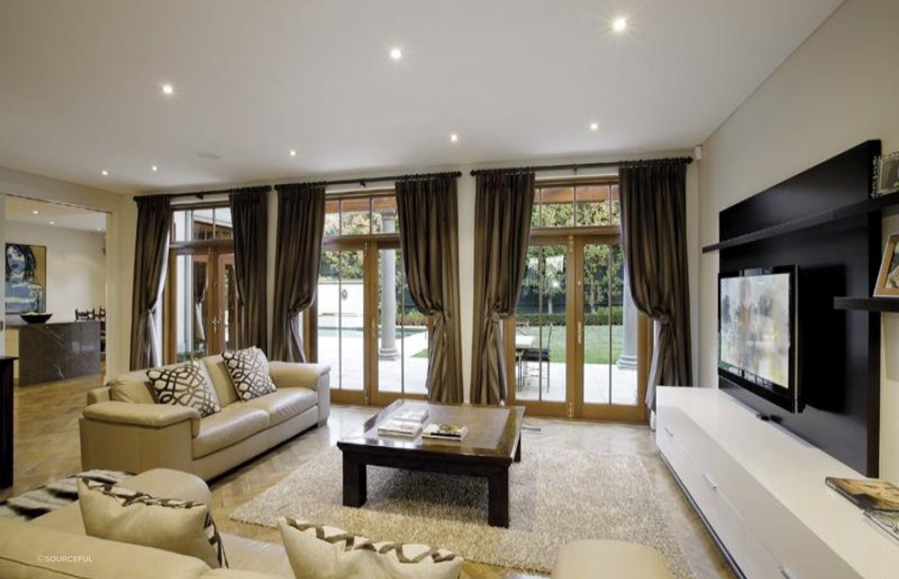 Family room - A moody interior was created utilising hand pleated drapes and bespoke rods and holdbacks.