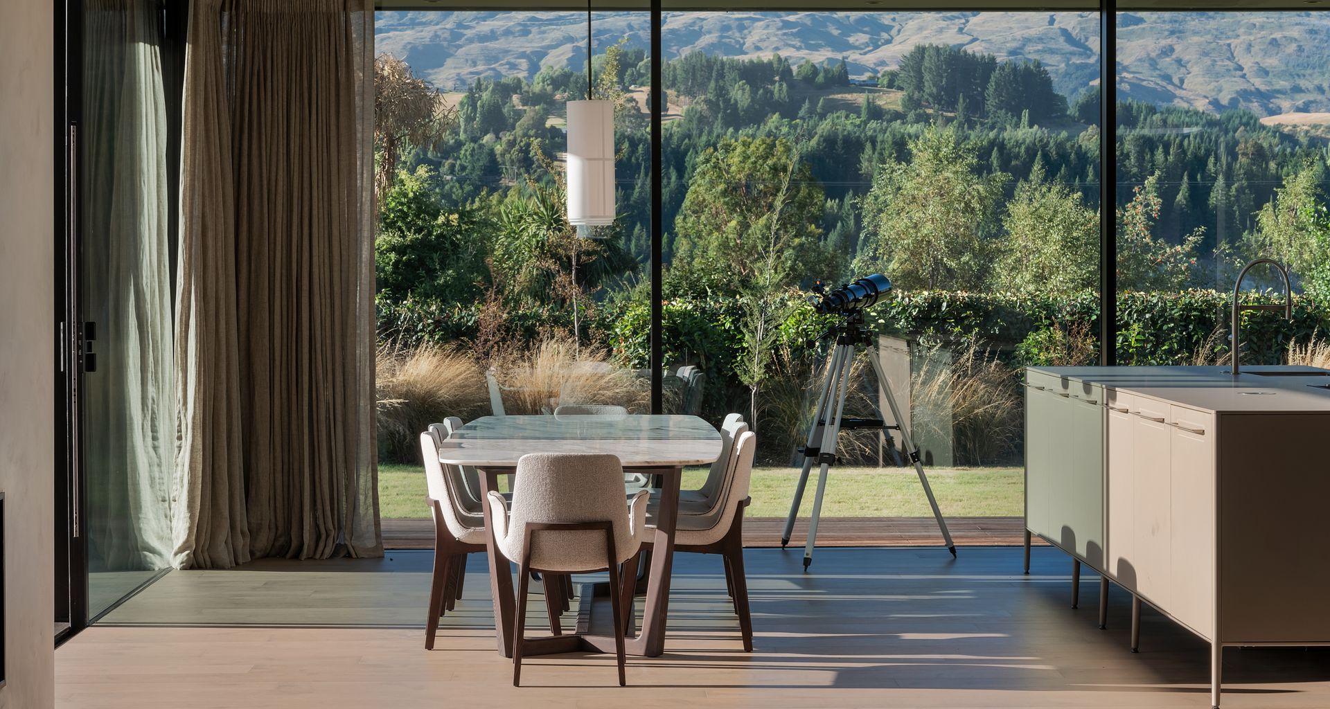 Dining room views to Coronet Peak. Featuring Poliform dining table and chairs from Studio Italia, Forte flooring oak floors.