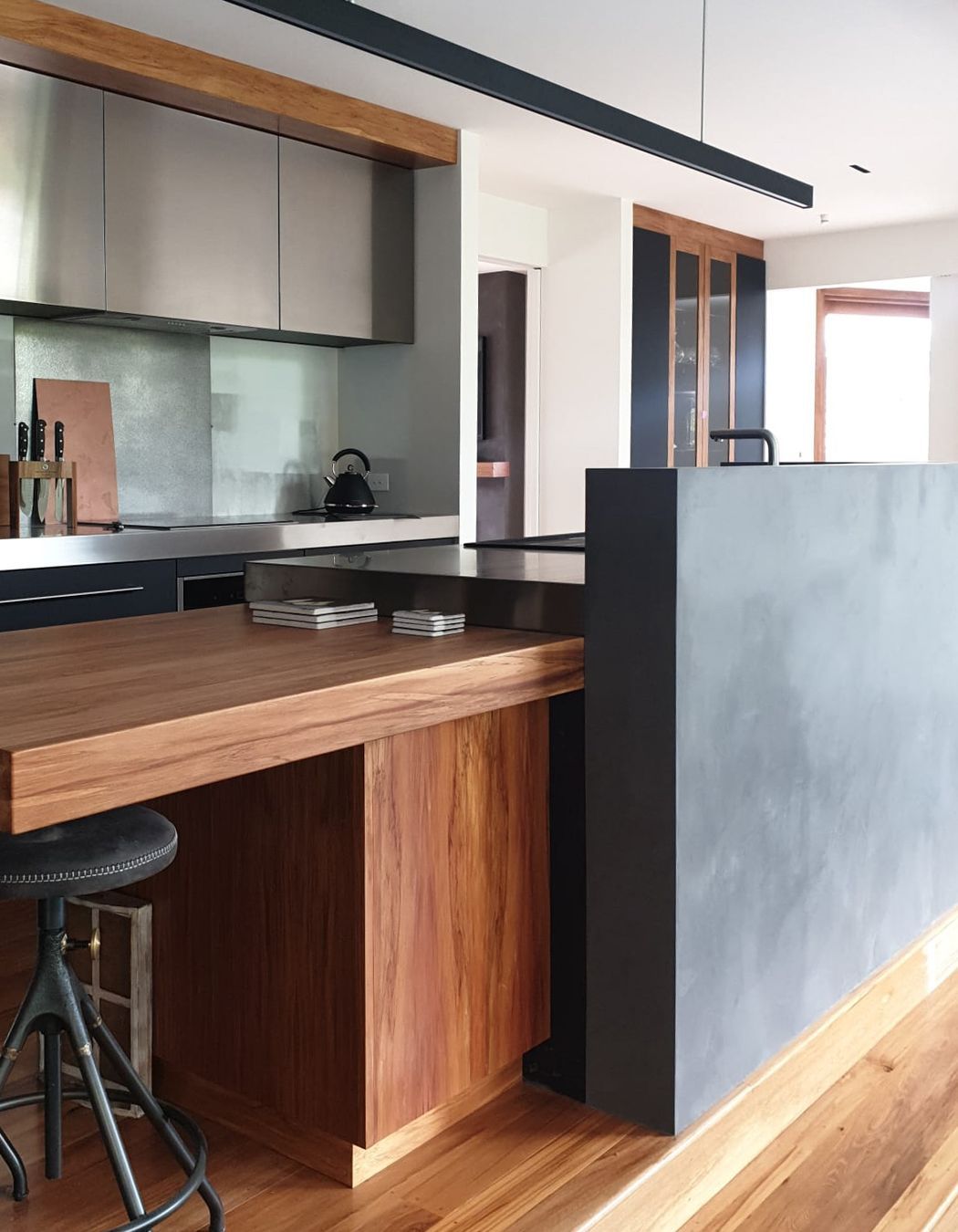 Tinted polished plaster to a dark colour and applied to this curved kitchen wall