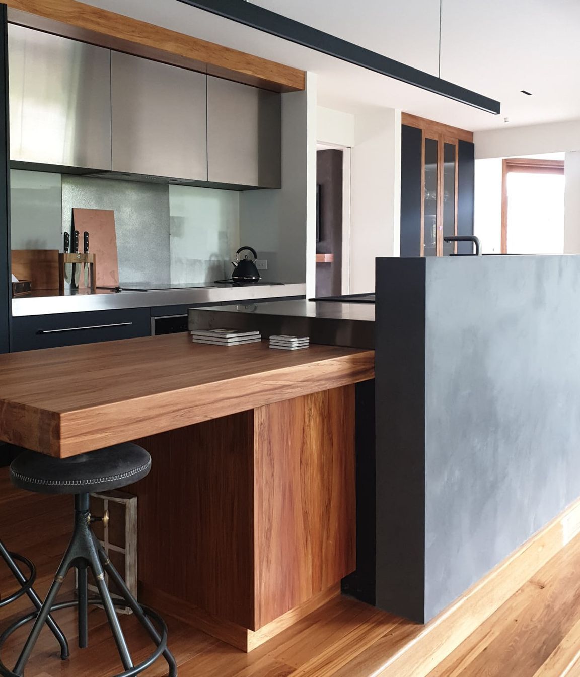 Tinted polished plaster to a dark colour and applied to this curved kitchen wall