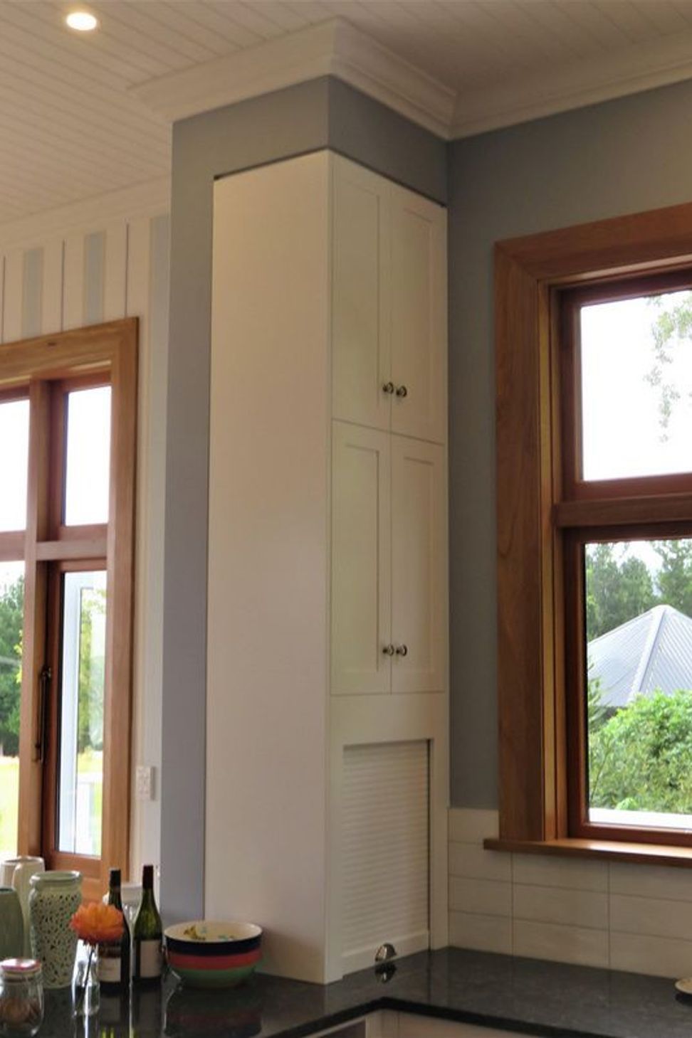 Even a narrow space can be beautifully defined storage in this kitchen
