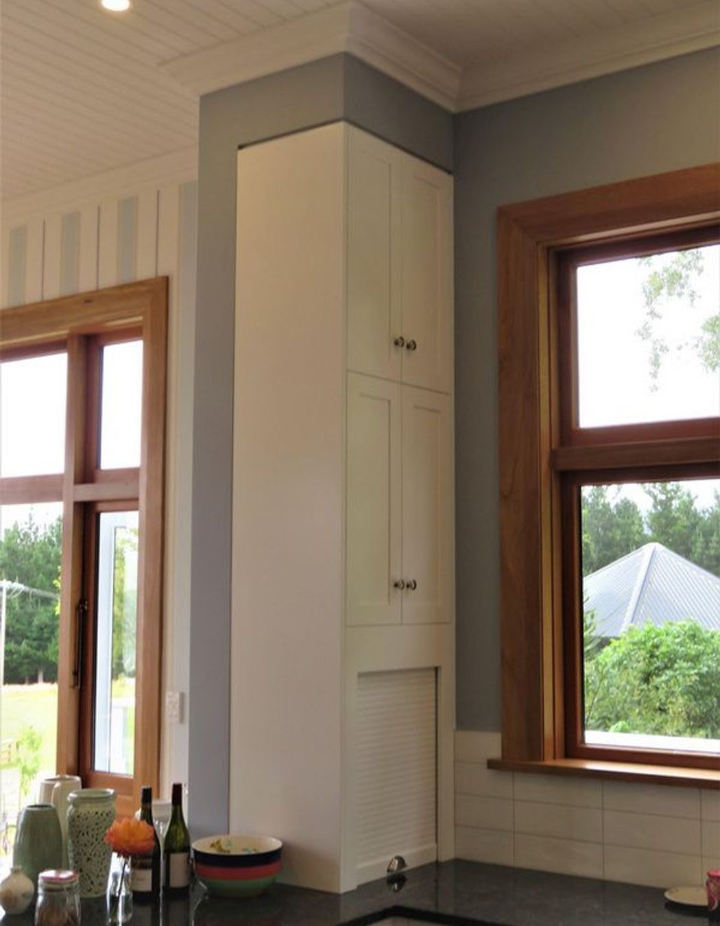 Even a narrow space can be beautifully defined storage in this kitchen