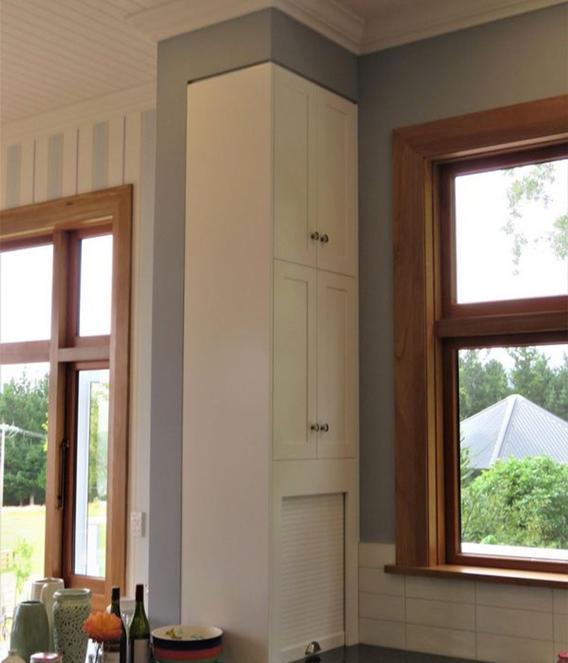 Even a narrow space can be beautifully defined storage in this kitchen