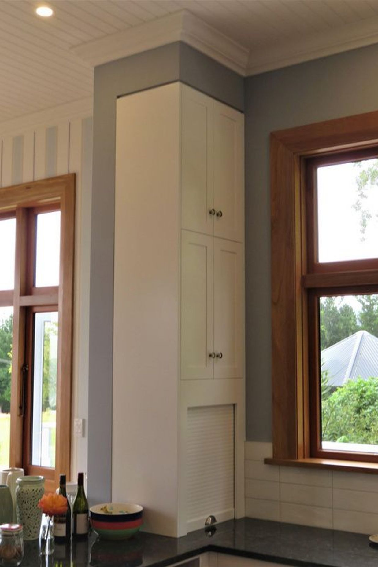 Even a narrow space can be beautifully defined storage in this kitchen