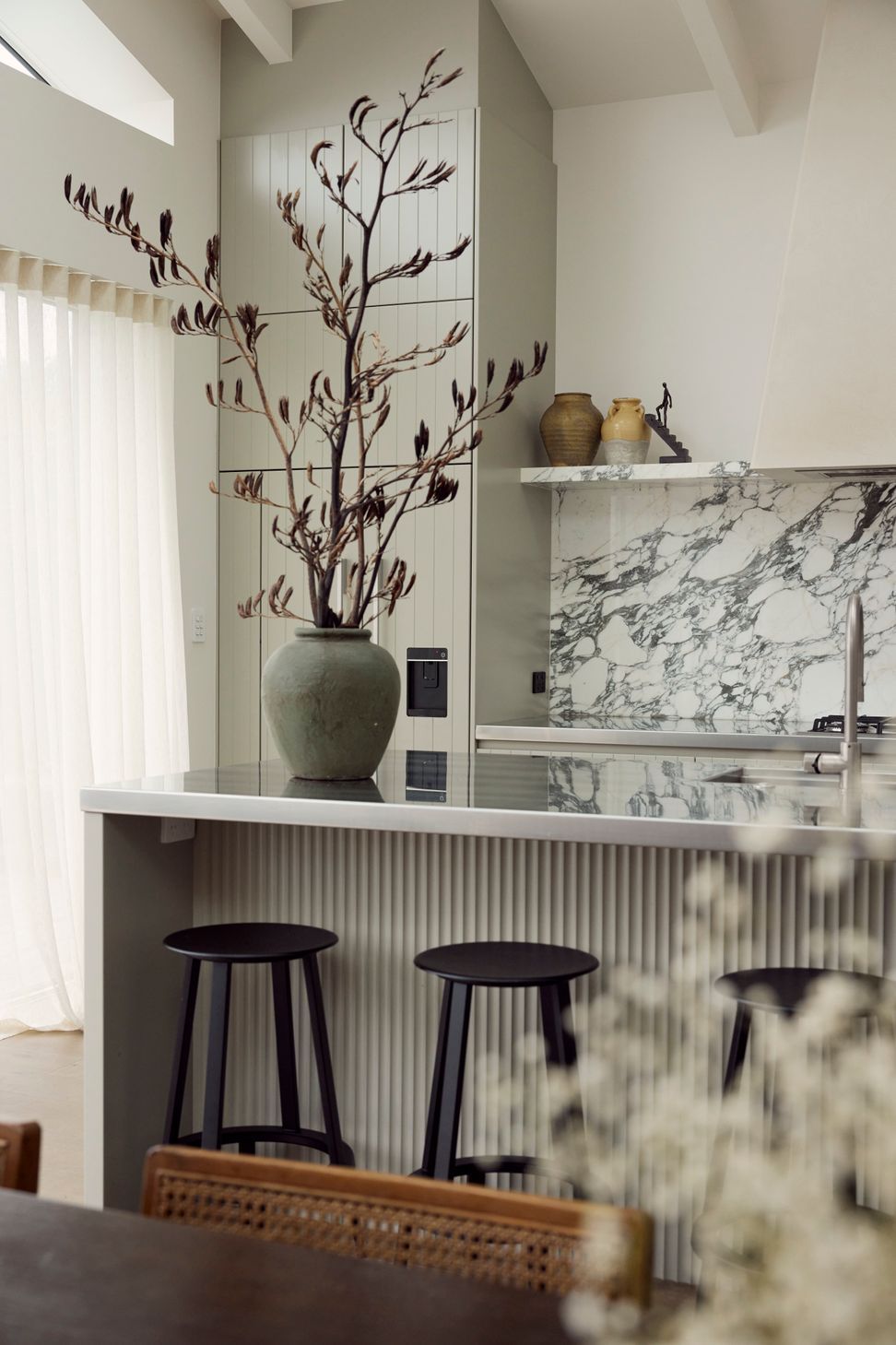Arabescato marble splashback, fluted island bench and sage green cabinetry — the kitchen at Point Chevalier Bungalow in close detail. In collaboration with Hannah Warren Interiors.