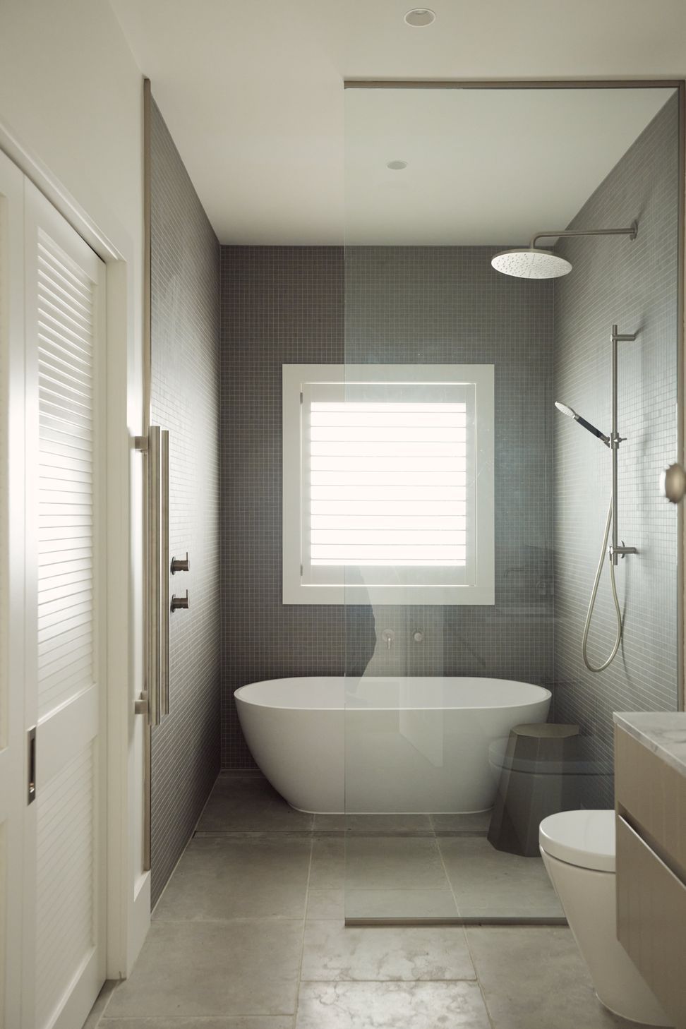 The master bathroom at Point Chevalier Bungalow — freestanding bath, mosaic tiling and rain shower within a beautifully resolved heritage renovation. In collaboration with Hannah Warren Interiors.