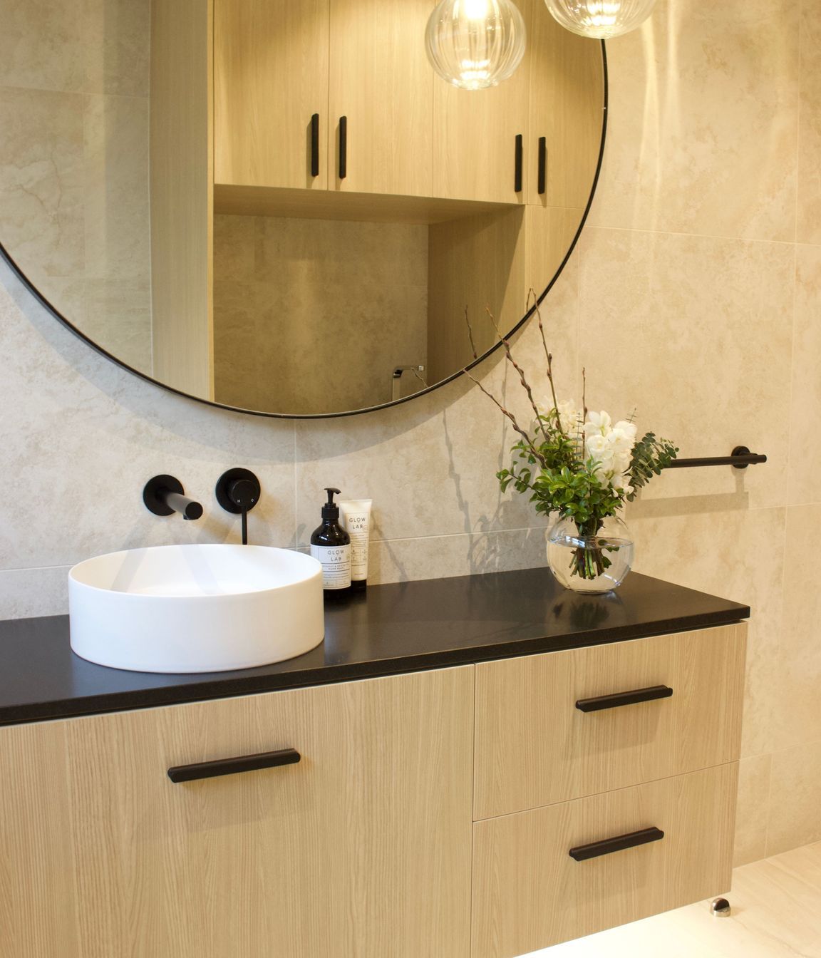 This stylish floor to ceiling tiled bathroom was a welcomed addition second bathroom and combined laundry to this family's villa