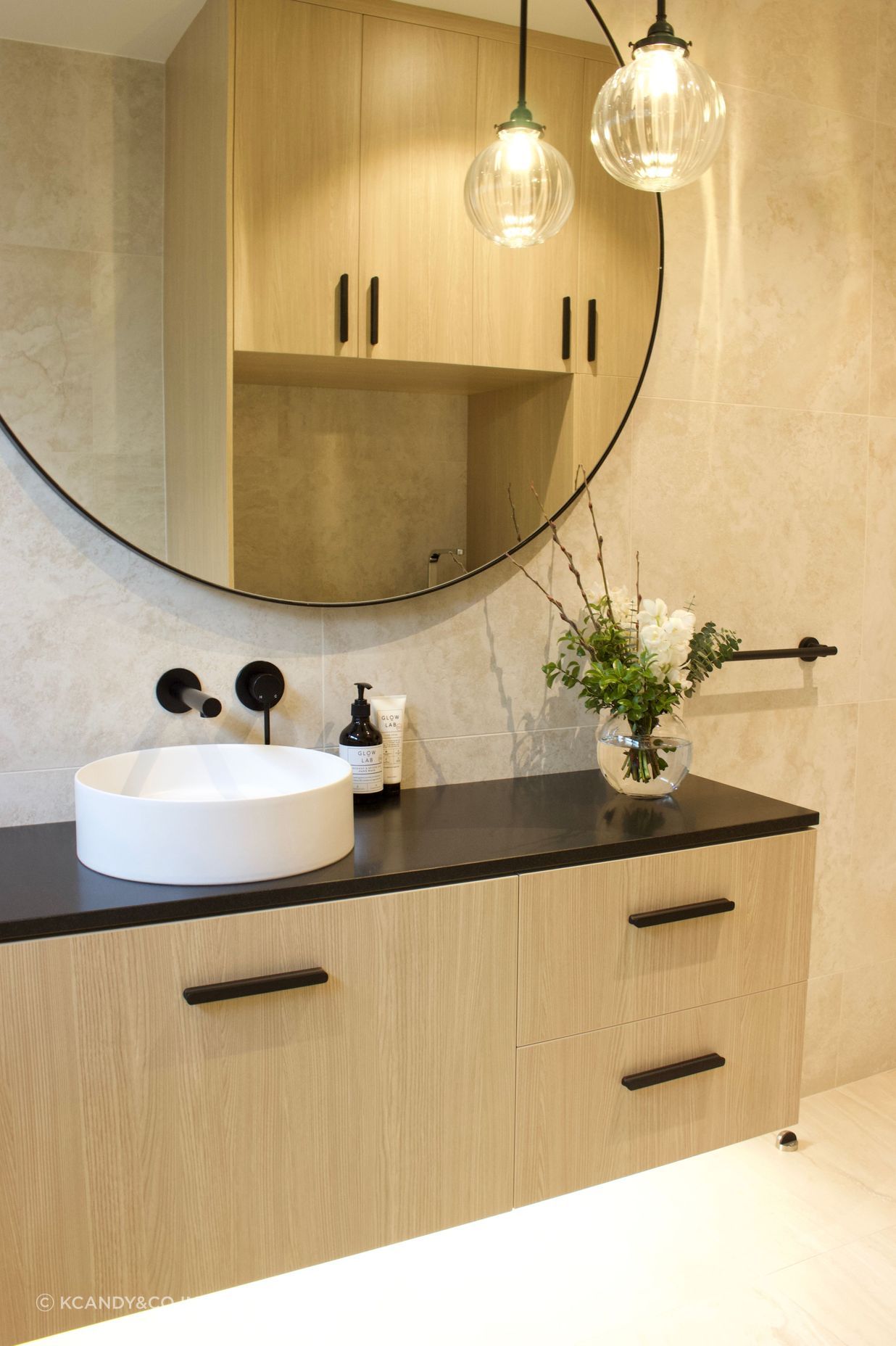 This stylish floor to ceiling tiled bathroom was a welcomed addition second bathroom and combined laundry to this family's villa