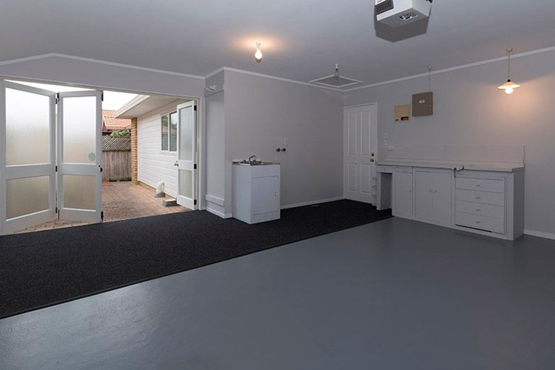 Garage - Following through with the paint colours we also added carpet to the back part of this is a rather large garage/laundry