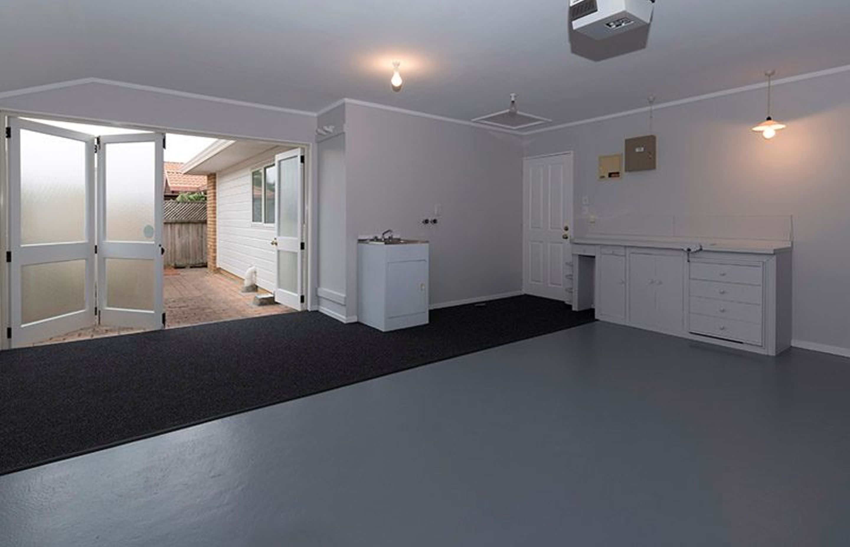 Garage - Following through with the paint colours we also added carpet to the back part of this is a rather large garage/laundry
