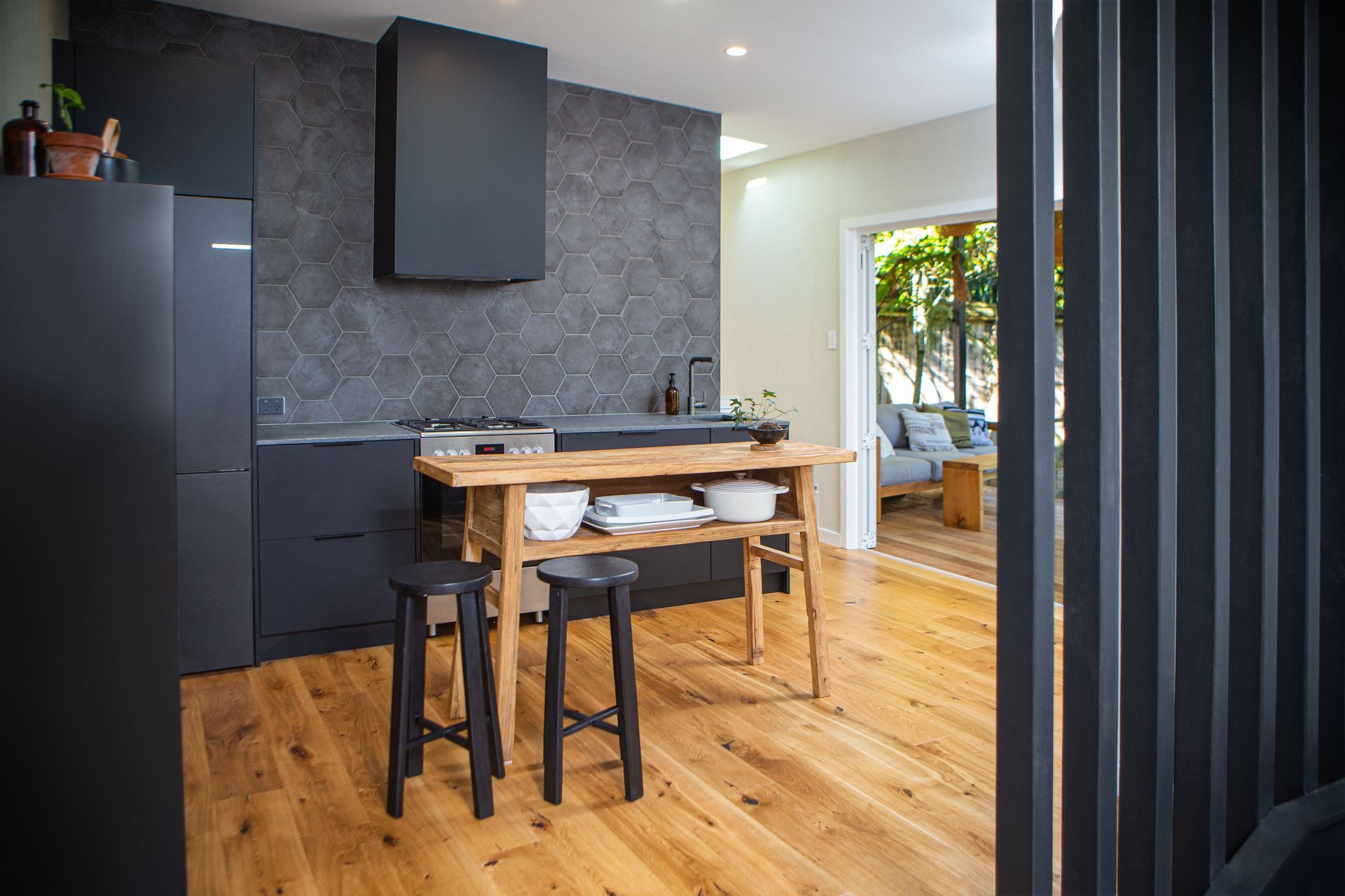 A small rustic console table is utilised as the island bench, for flexibility when entertaining.