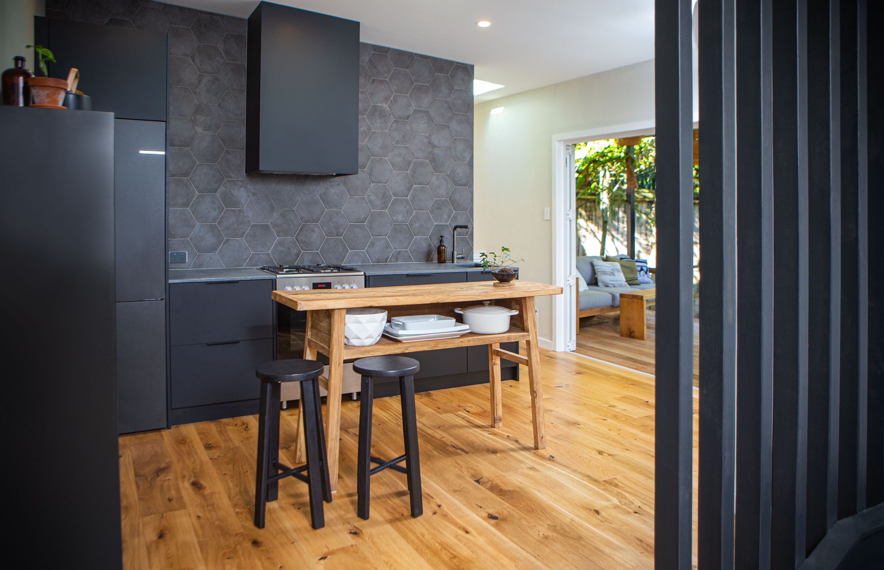 A small rustic console table is utilised as the island bench, for flexibility when entertaining.