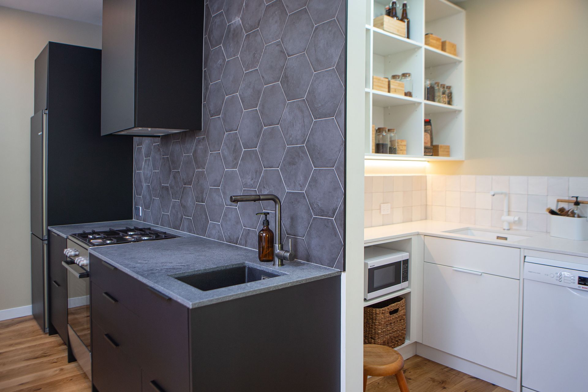 Dark and light - the scullery and pantry are tucked out of sight with ample storage and dishwashing space. Two sinks a must for this homeowner.