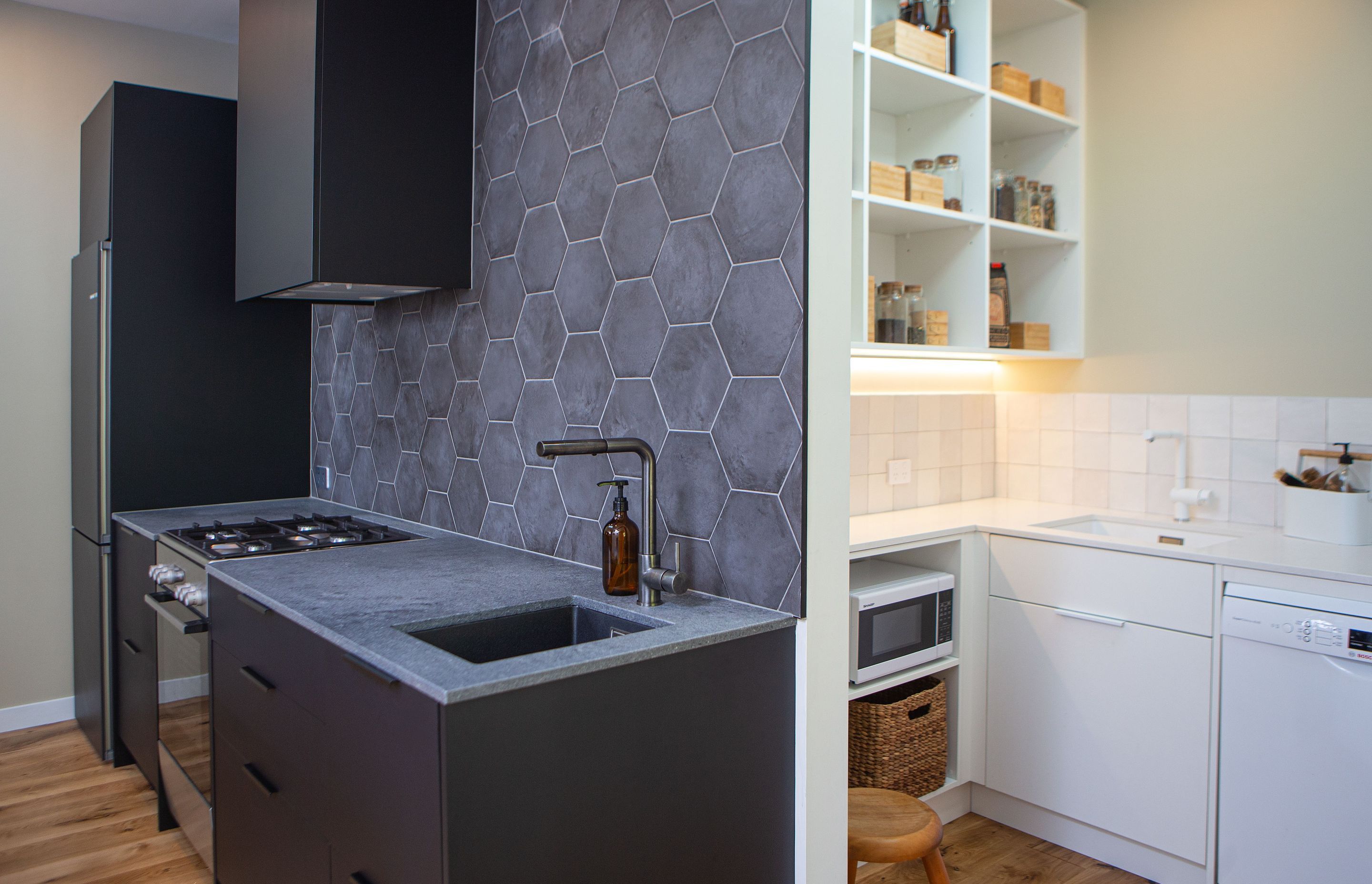 Dark and light - the scullery and pantry are tucked out of sight with ample storage and dishwashing space. Two sinks a must for this homeowner.