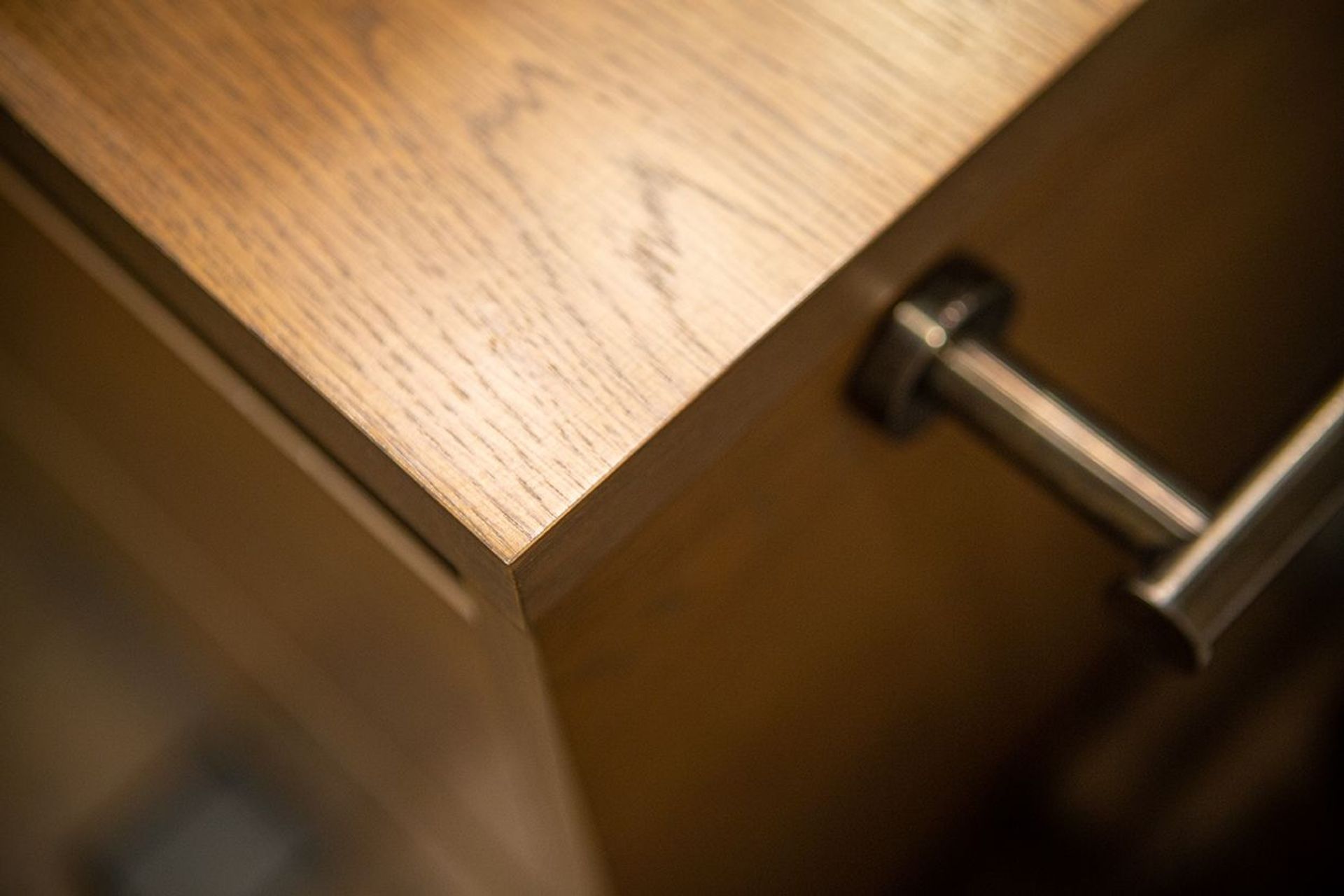 Aged iron towel rail bar is mounted to the side of the vanity for best access.