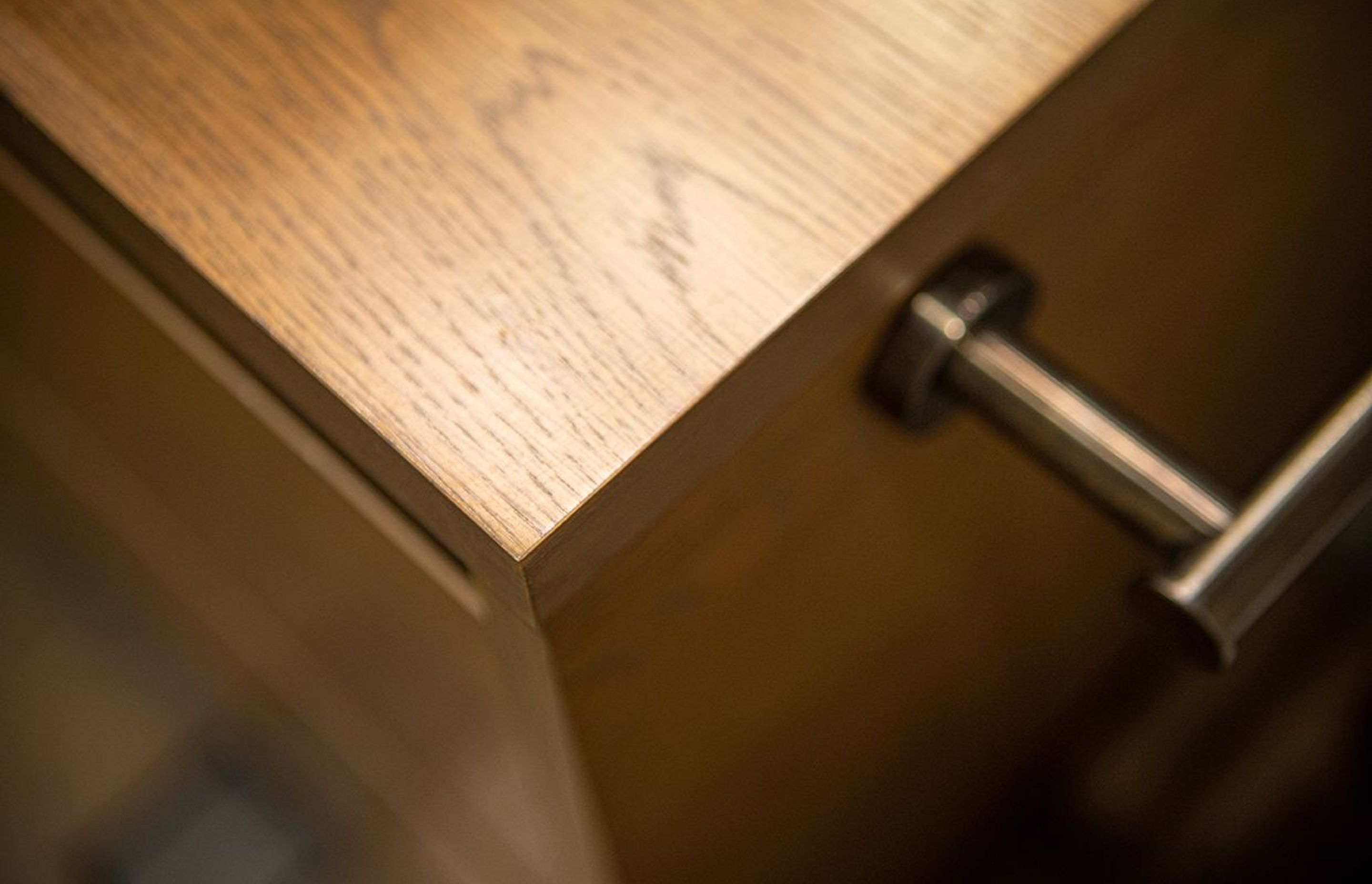 Aged iron towel rail bar is mounted to the side of the vanity for best access.