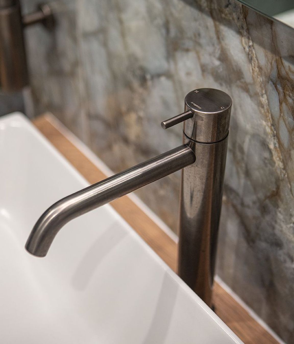 Aged iron basin mixer sits perfectly alongside the Patagonia tile.