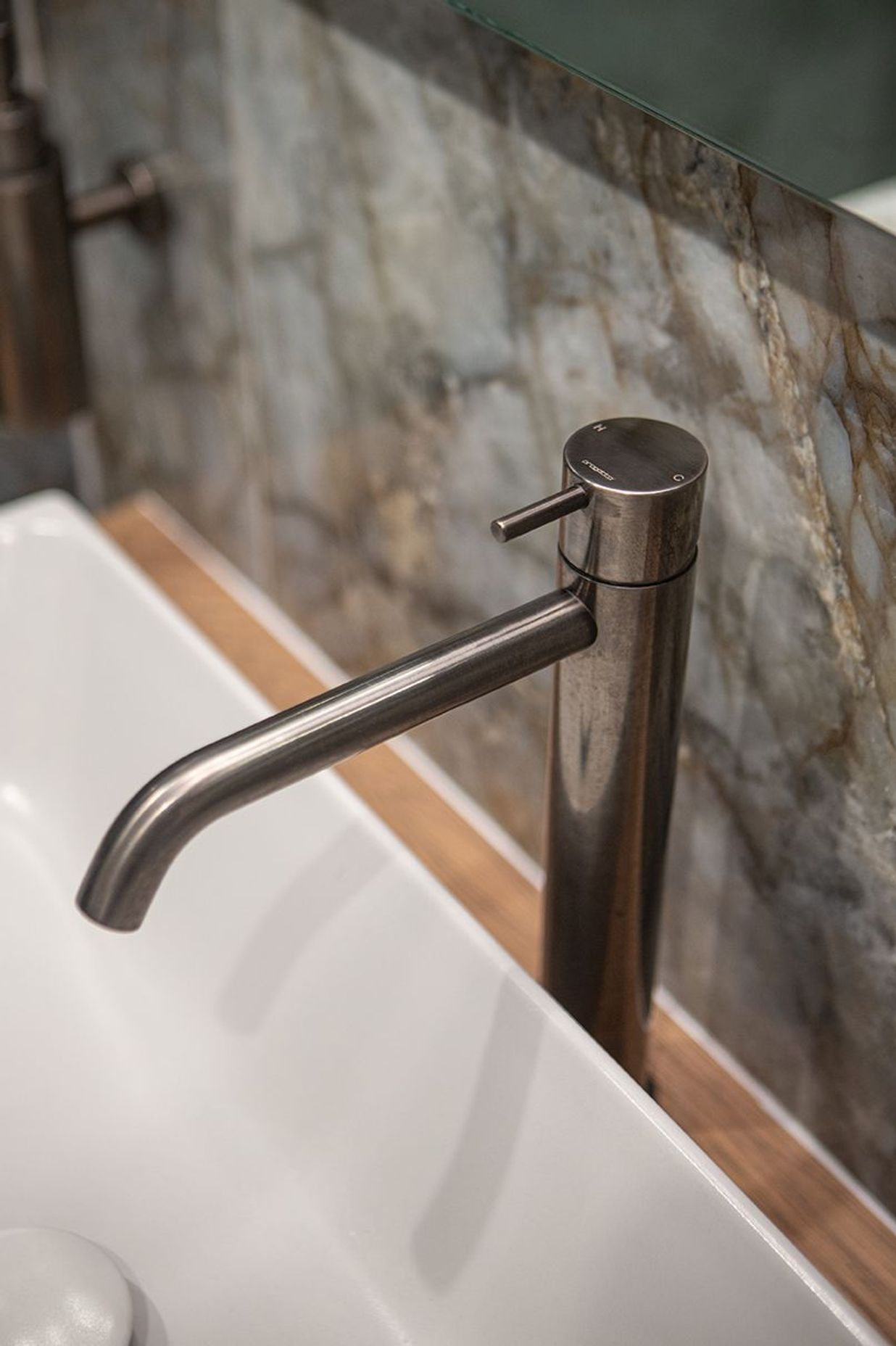 Aged iron basin mixer sits perfectly alongside the Patagonia tile.