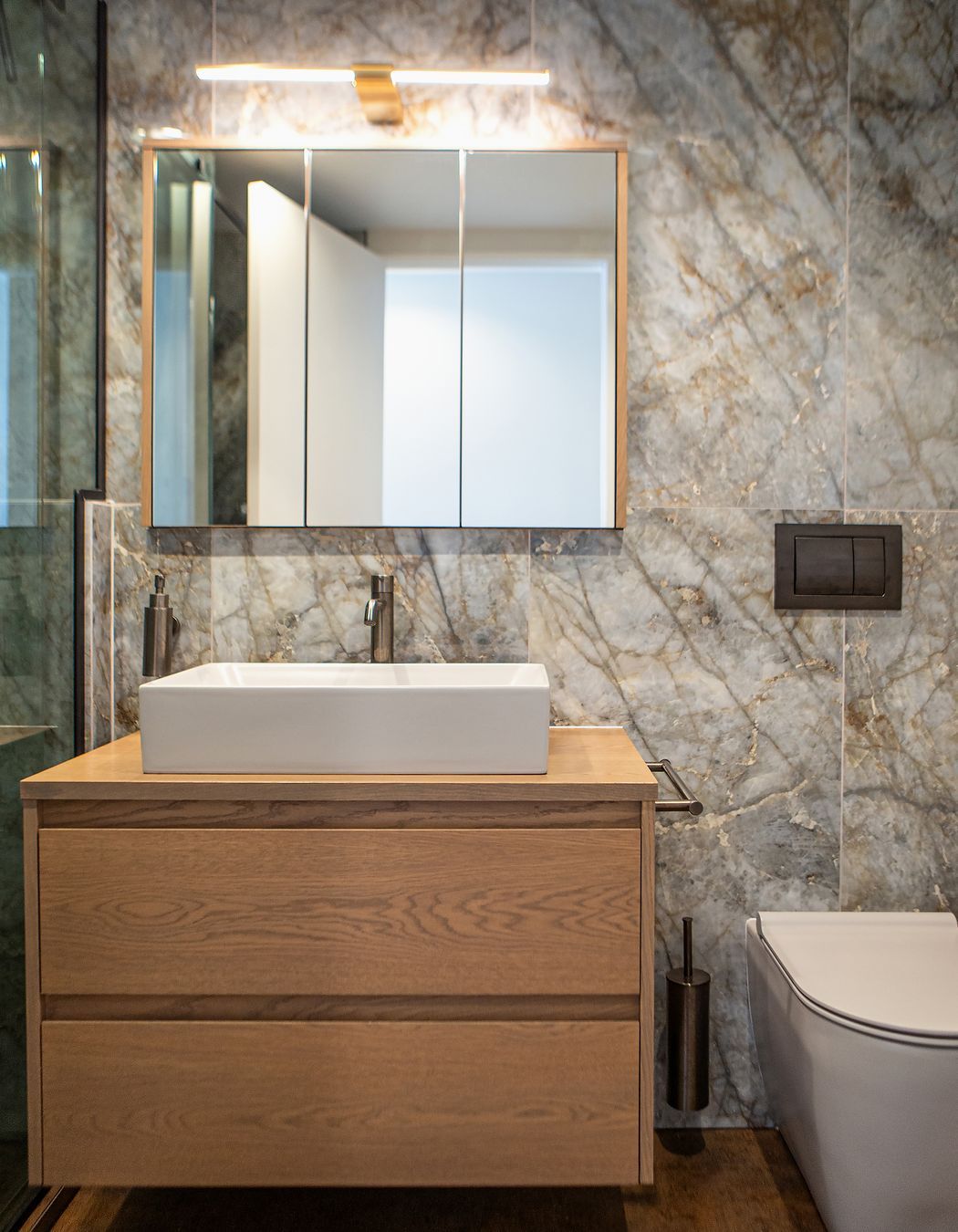 Simple yet elegant vanity set up, with a stunning light fixture from Hinkley Vaughn.