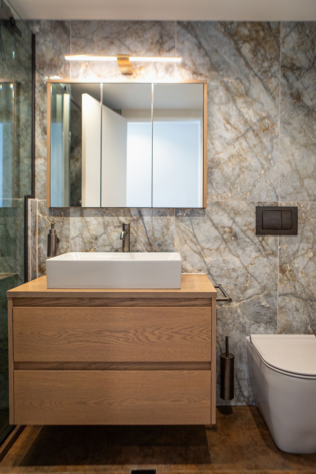 Simple yet elegant vanity set up, with a stunning light fixture from Hinkley Vaughn.