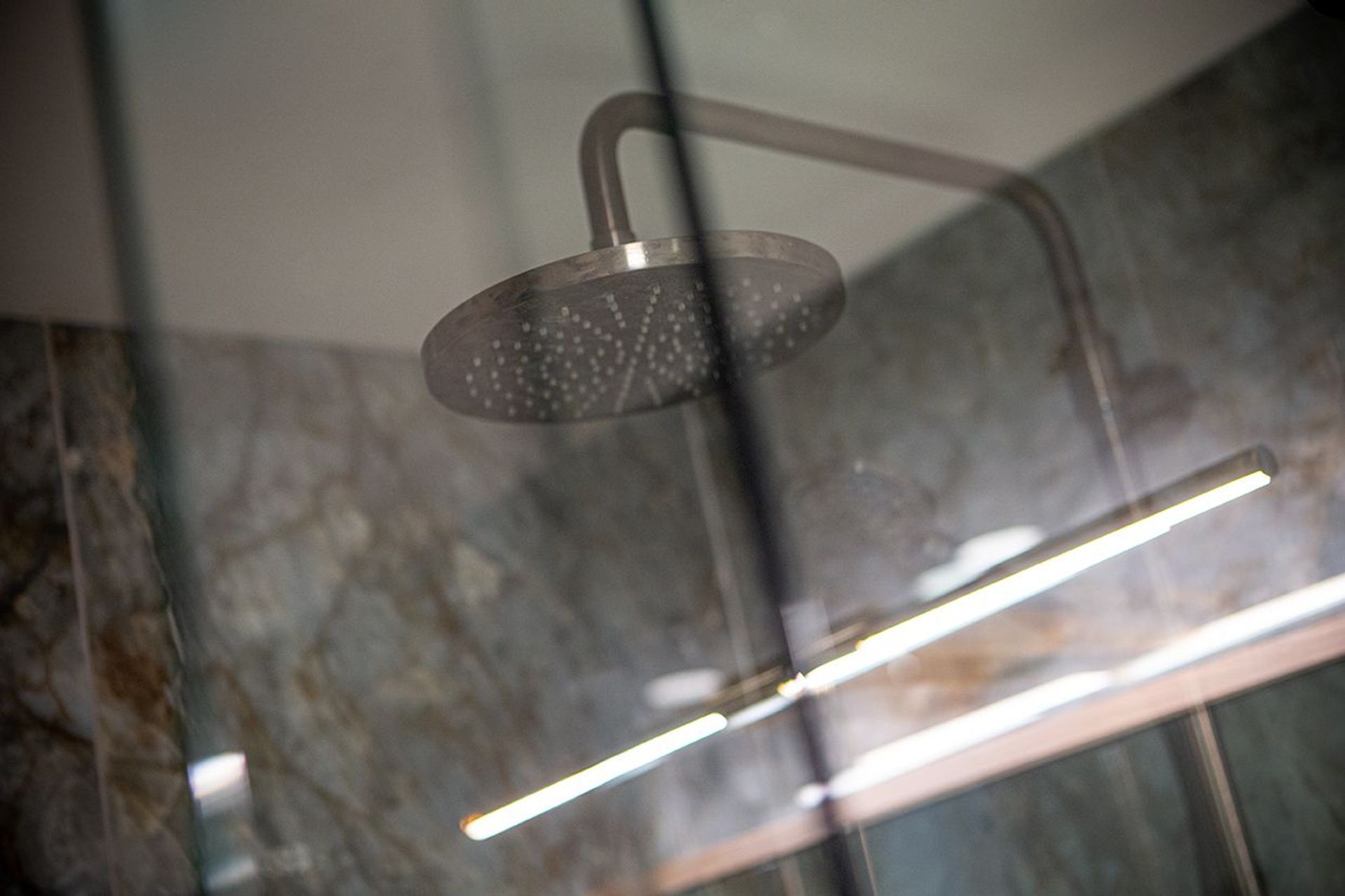 Luxurious aged iron shower dumper and rail.