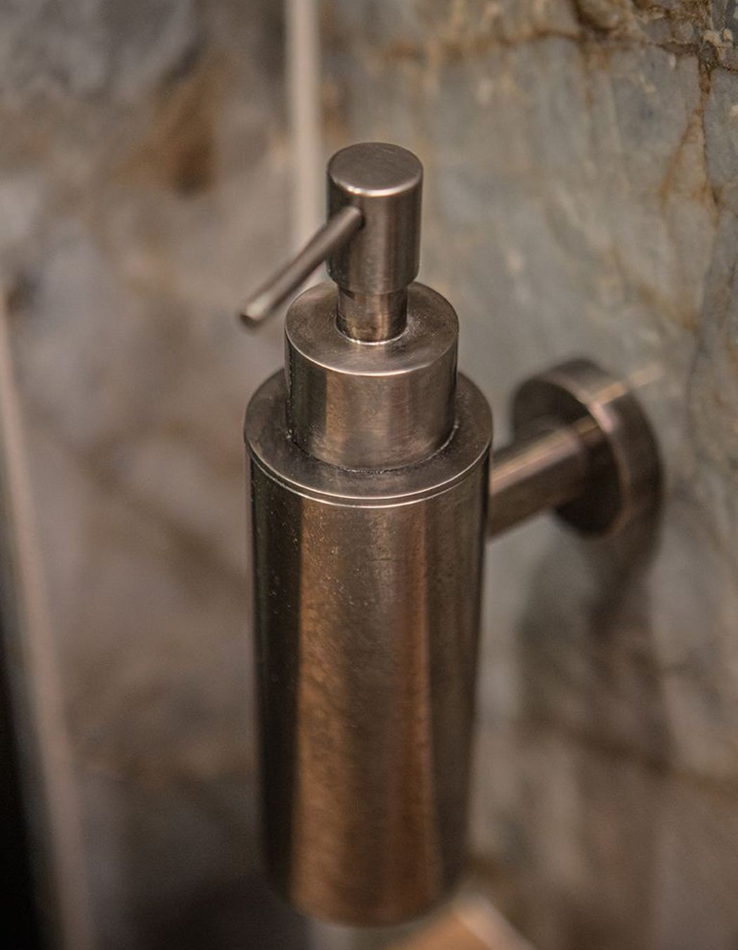 And an aged iron wall mounted soap dispenser to match.