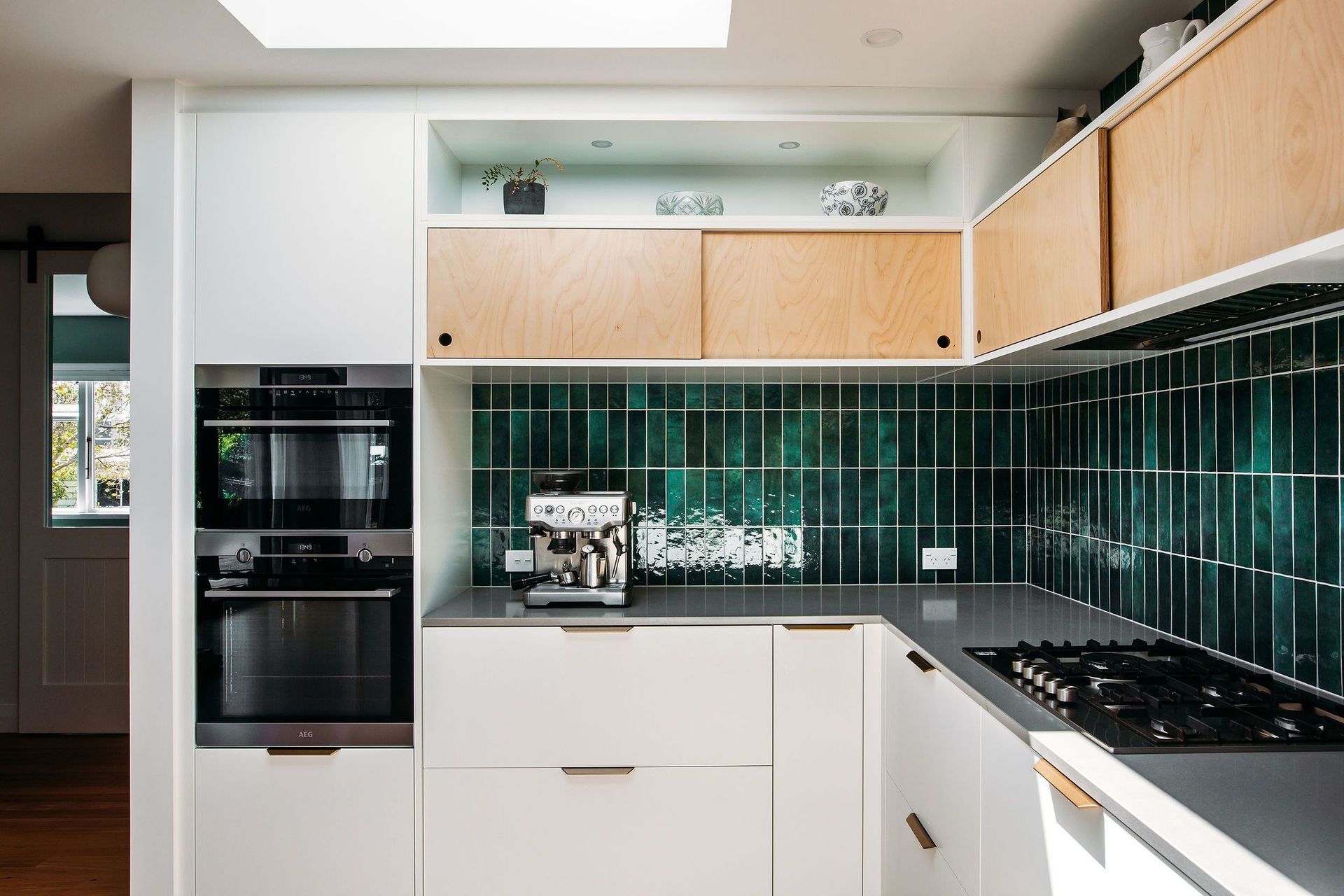 The skylight and open shelving at high level help to bright light and a sense of space into this kitchen.