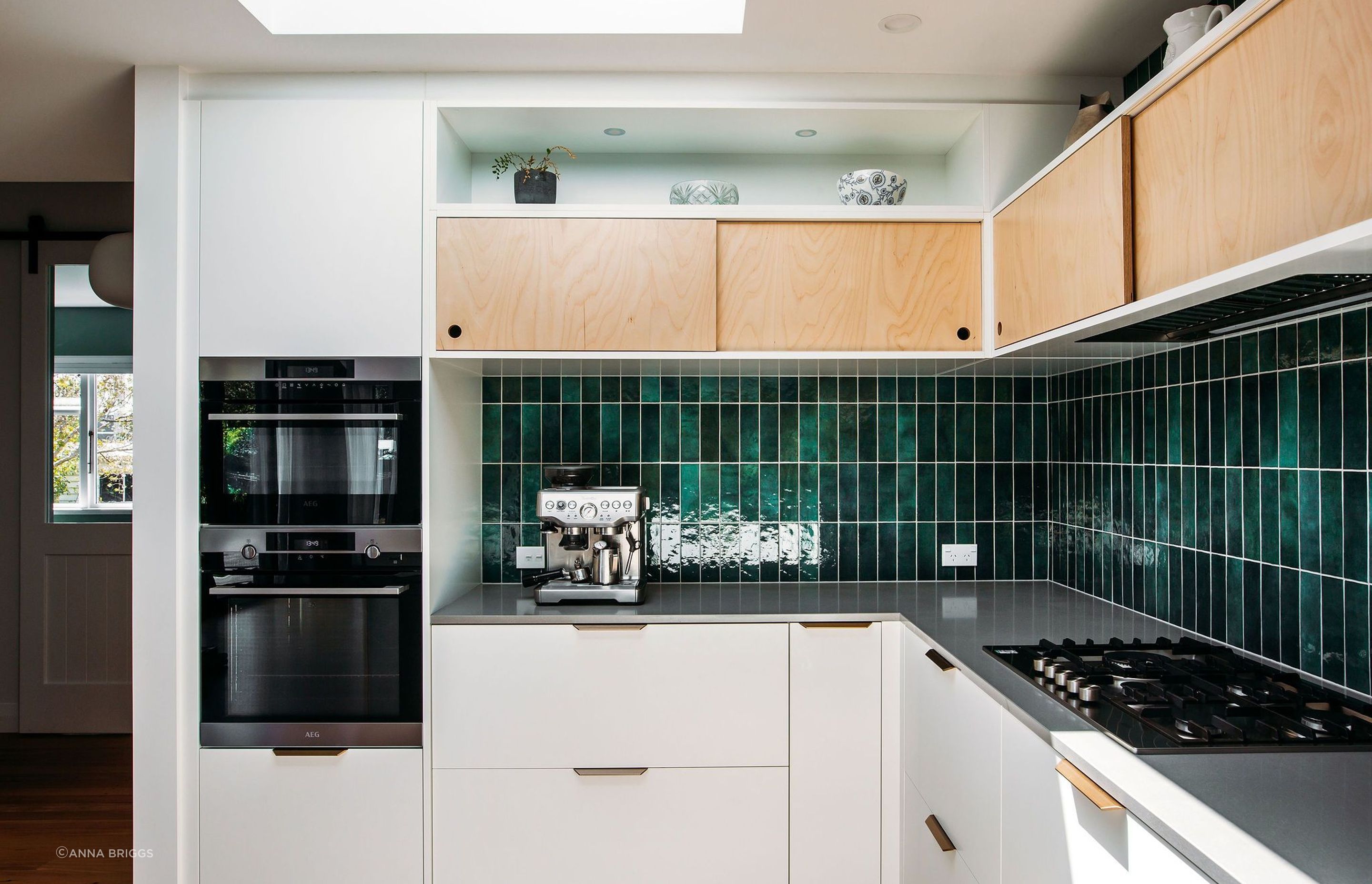 The skylight and open shelving at high level help to bright light and a sense of space into this kitchen.