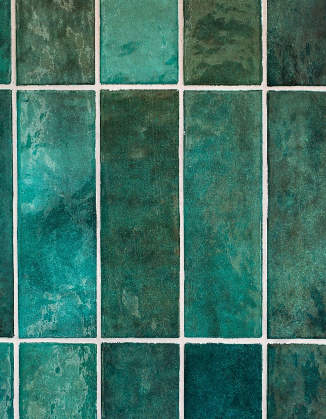 Emerald green tiles are laid vertically on the kitchen splashback.