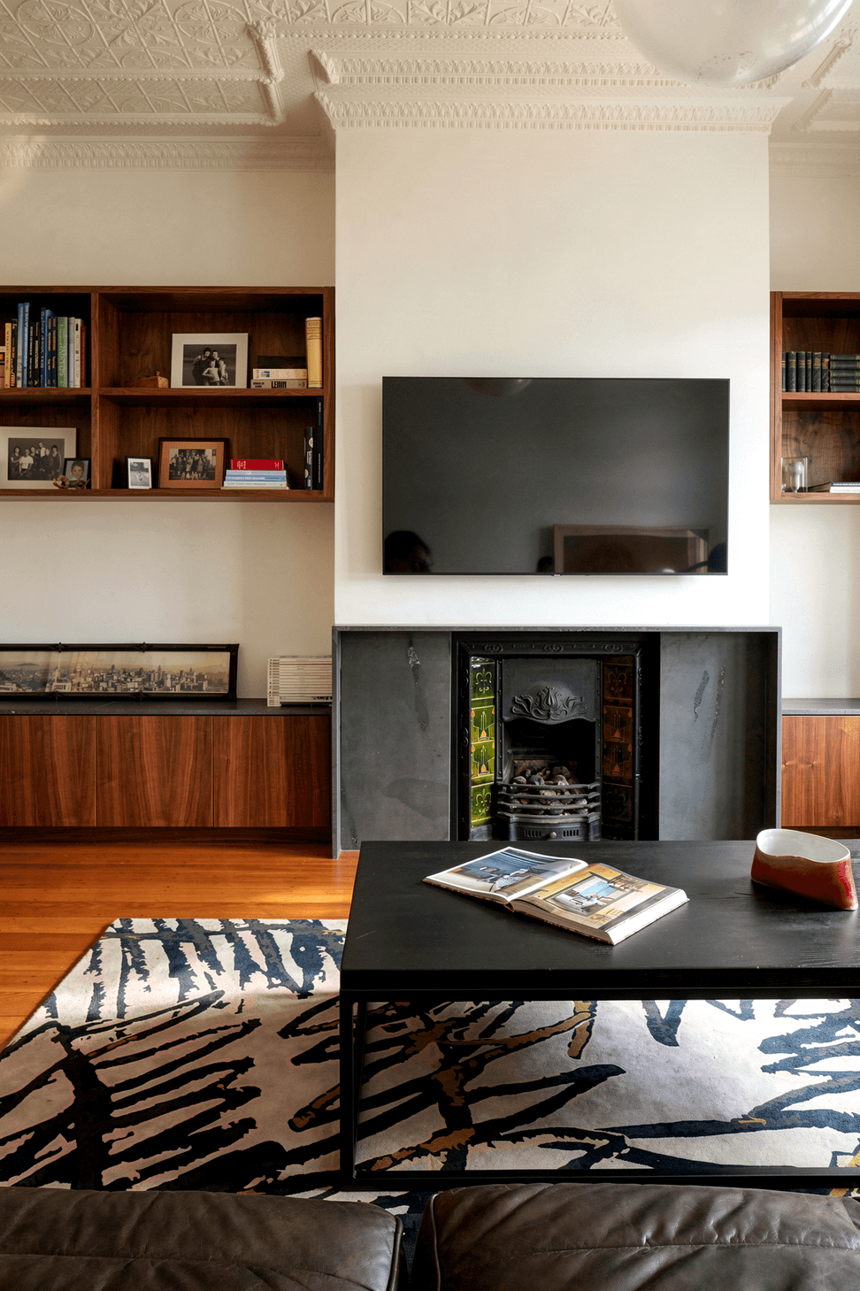 The separate lounge celebrates the heritage character of the original Mt Eden villa through the careful restoration of its pressed metal ceiling, ornate fireplace and period detailing. Thoughtfully preserved and refreshed, these original features create a warm, inviting space that honours the home's history while supporting contemporary family living.