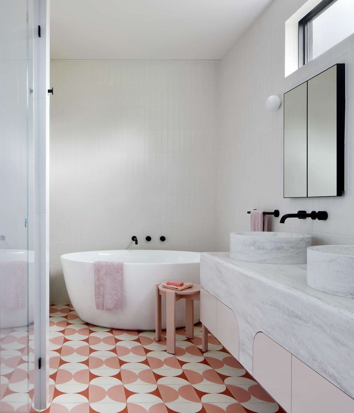 Art Deco inspired large ensuite bathroom with pink and cream Butterfly tile from Perini, featuring a top mounted, double sink from corian, Forme L'isola  Freestanding Bath  and walk in shower.   Located in Melbourne, see more from our Arch Deco Project. The colour scheme references the colours used commonly during the Art Deco period of the house.