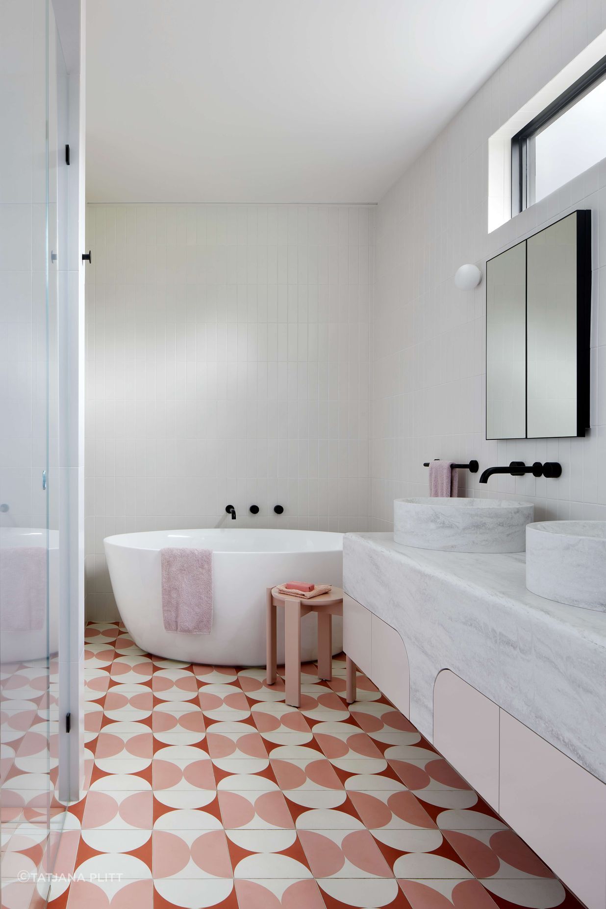 Art Deco inspired large ensuite bathroom with pink and cream Butterfly tile from Perini, featuring a top mounted, double sink from corian, Forme L'isola Freestanding Bath and walk in shower. Located in Melbourne, see more from our Arch Deco Project. The colour scheme references the colours used commonly during the Art Deco period of the house.