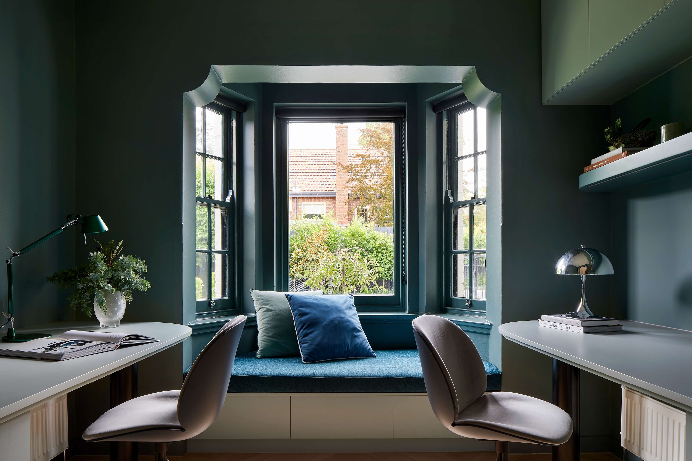 Home study in a 1930’s Spanish Mission renovation, with a reimagined art deco inspired design. Featuring a dark green garden aesthetic with jeweled green wall colour in Dulux Coriole. Arched doors and windows and jeweled coloured chairs contribute to an overall rich colour scheme. Located in Melbourne, see more from our Arch Deco Project.