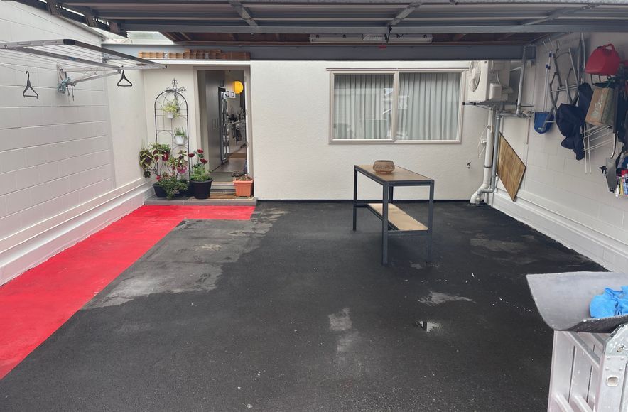 Open Carport/Garages with Asphalt floors and Ugly painted entrance way. Built on top of an existing Carpark complex. 25 Unit titles