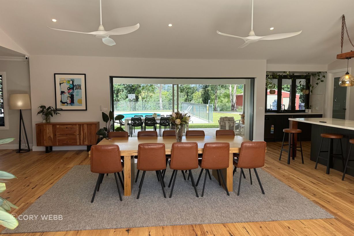 The interior combines the warmth of the timber floors and the industrial black kitchen with recycled timber beam and chains.
