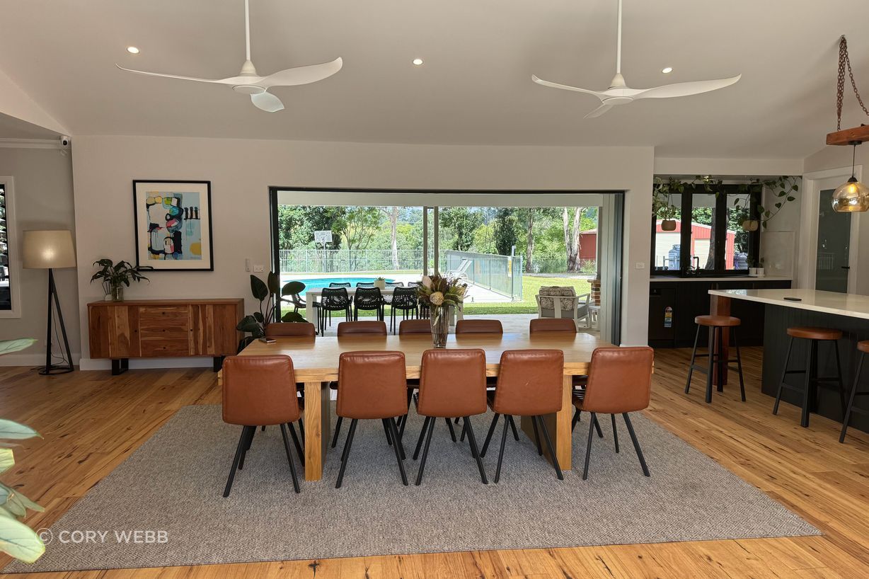 The interior combines the warmth of the timber floors and the industrial black kitchen with recycled timber beam and chains.