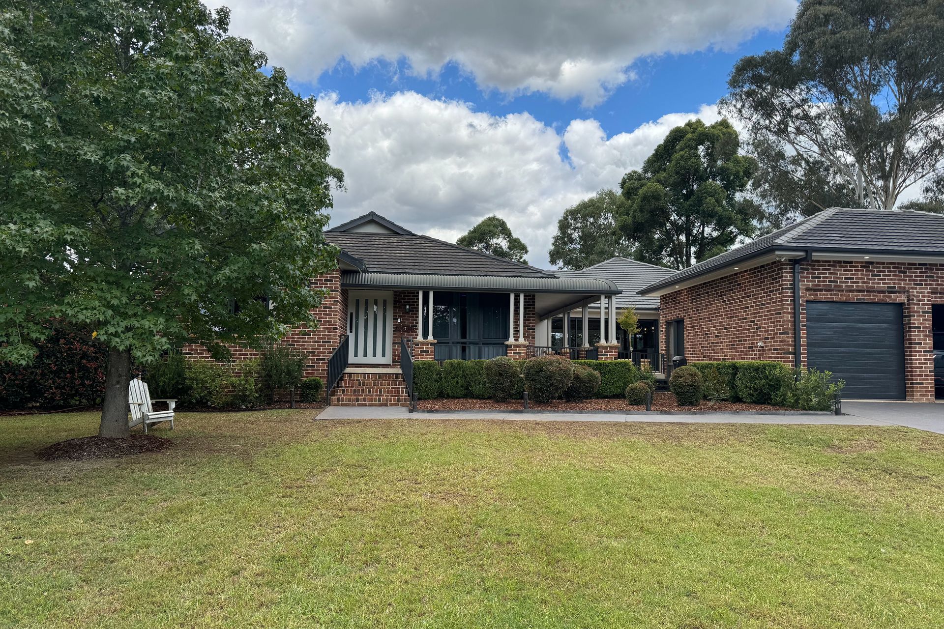 The street view of the red brick farmhouse only shows a small slice of the surprising addition to the rear of the property.