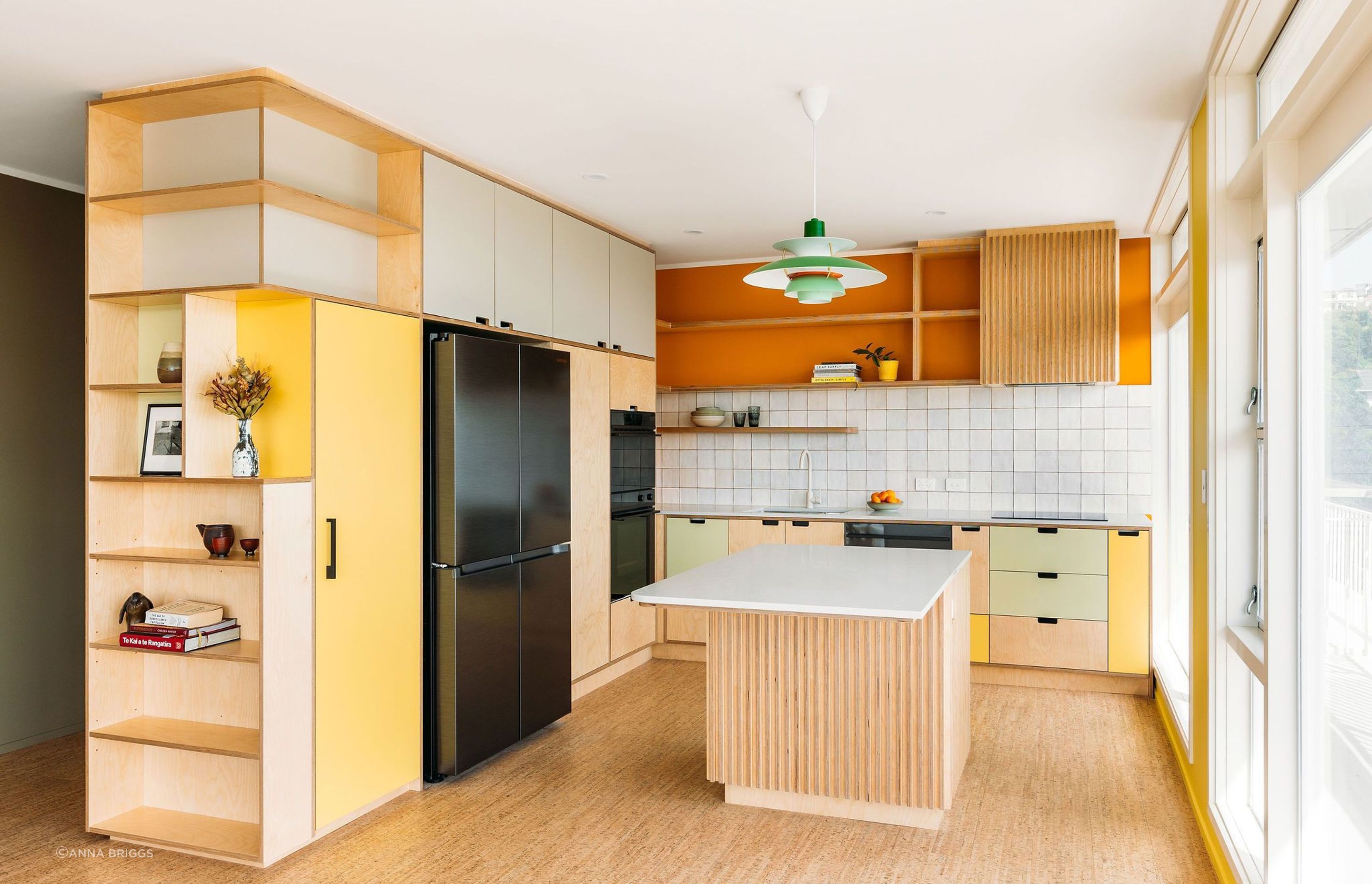 More library storage is incorporated into the kitchen cabinetry.