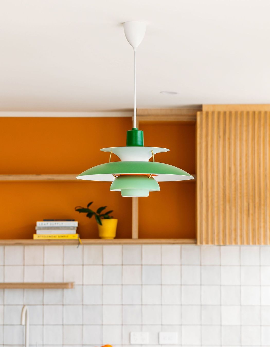 The replica PH5 lamp sits in perfect harmony with the mid-century inspired design and colour scheme.